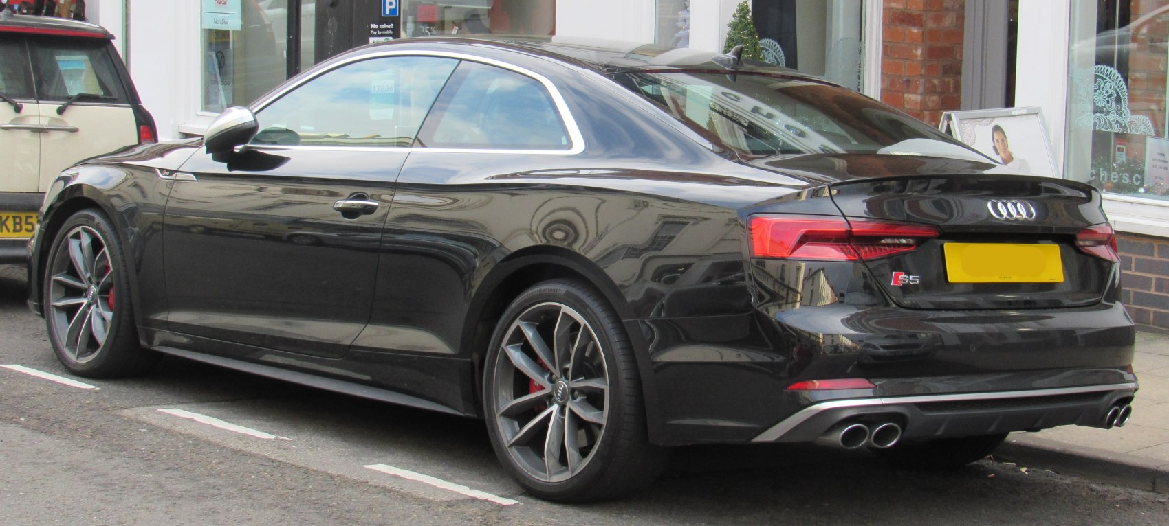 Rear side view with quad exhaust and signature taillights