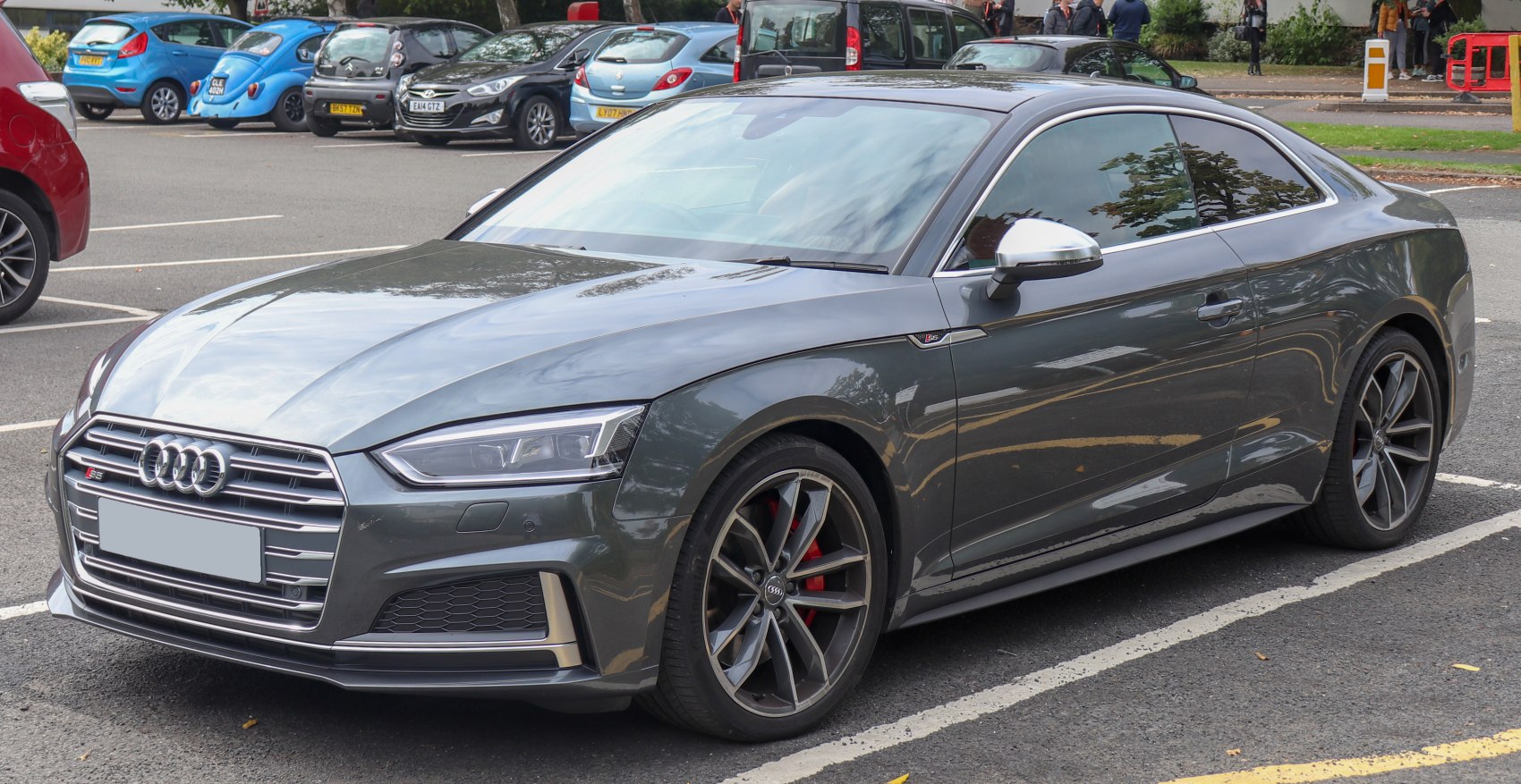 Front 3-4 angle of metallic grey coupe with sporty wheels