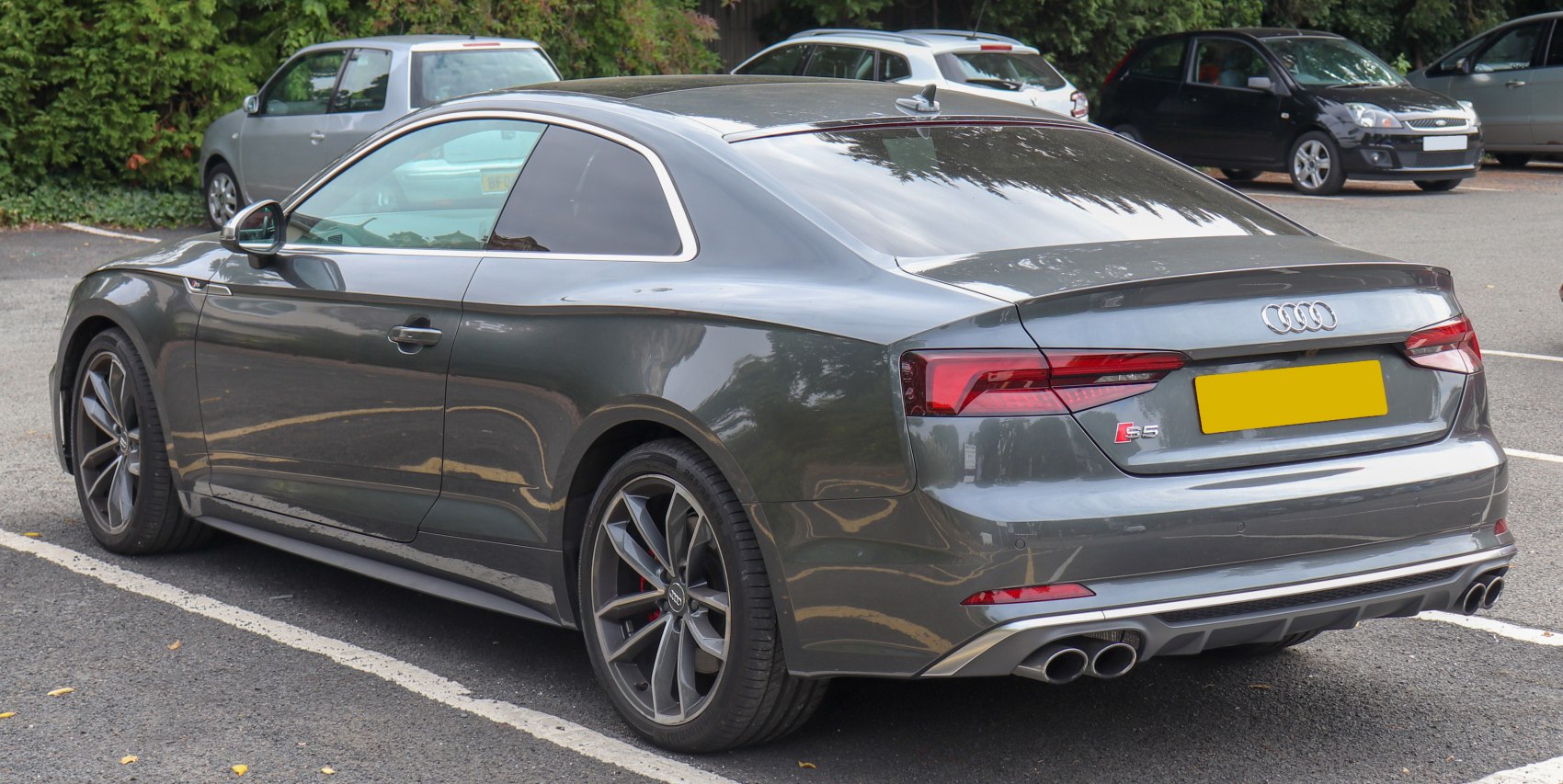 Sporty rear side view with quad exhaust and alloy wheels