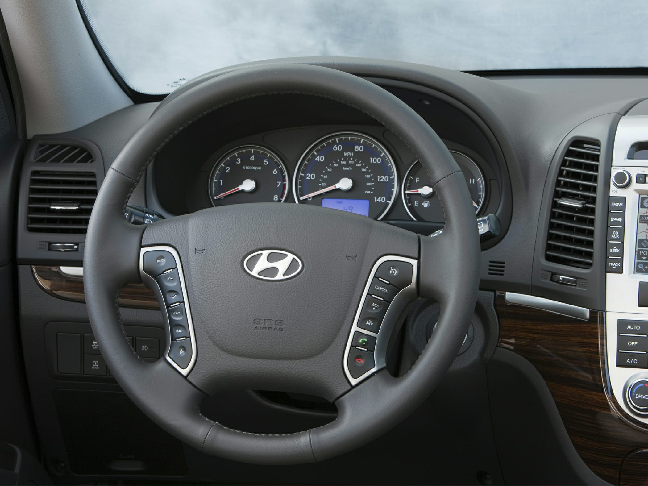 Steering wheel with controls and instrument cluster in car interior