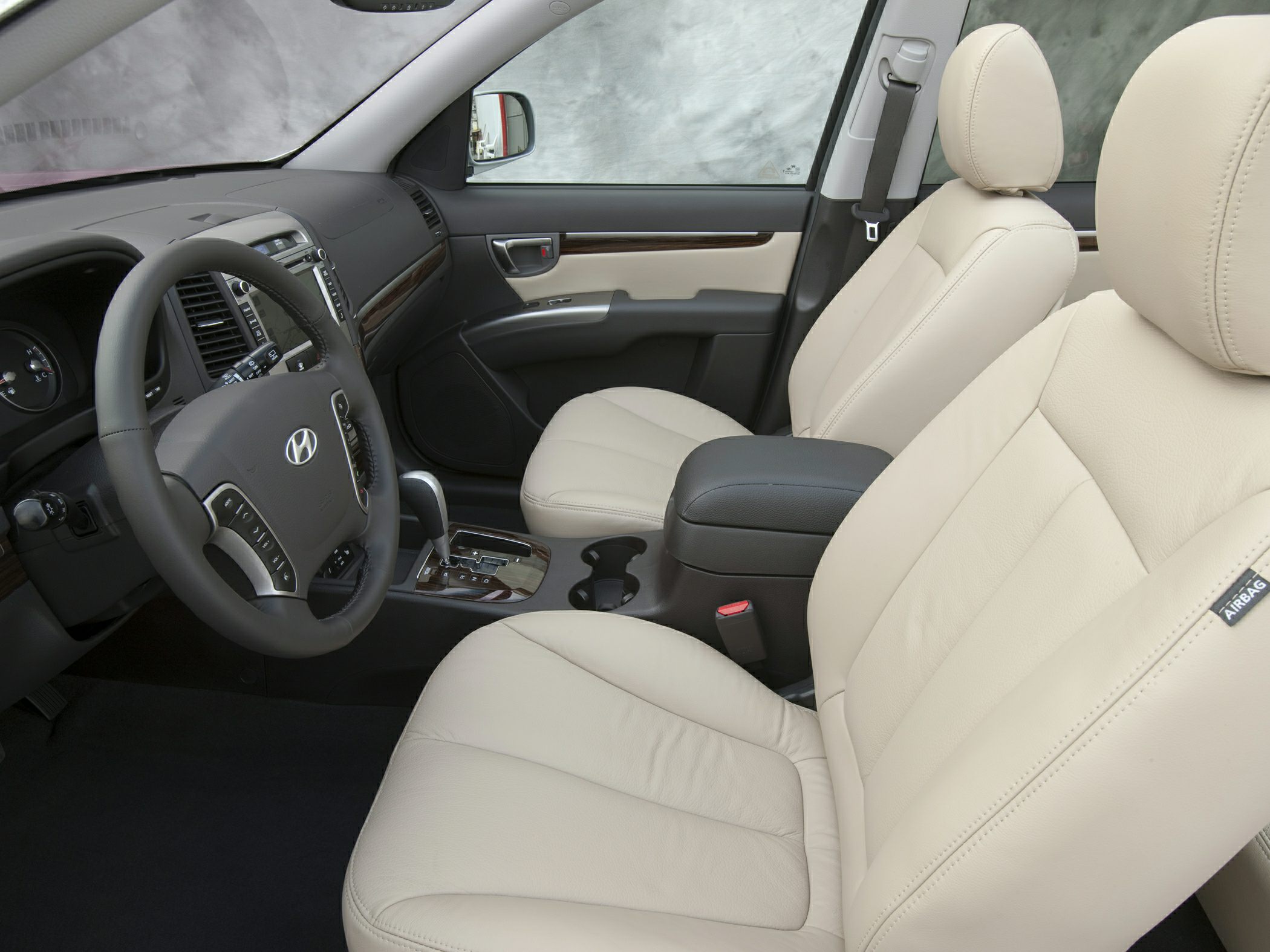 Beige leather seats and dashboard with wood trim interior