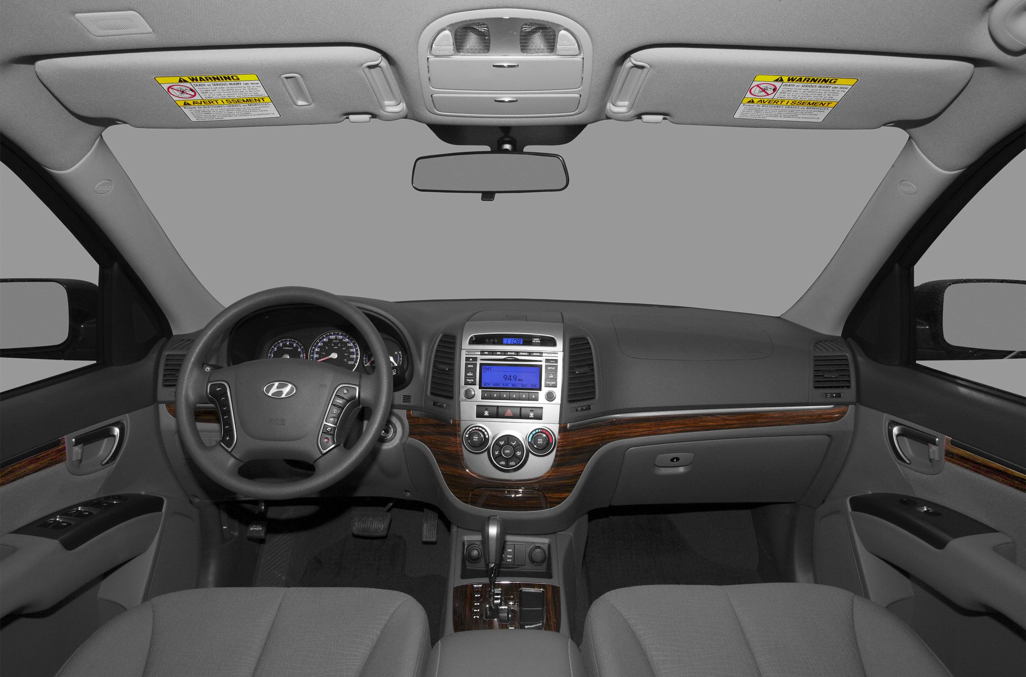 Interior dashboard with wood trim and multifunction steering wheel.