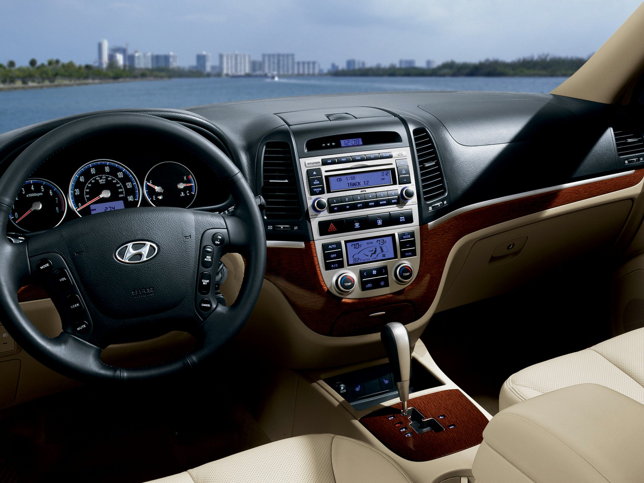 Interior dashboard, steering wheel, and center console with wood trim