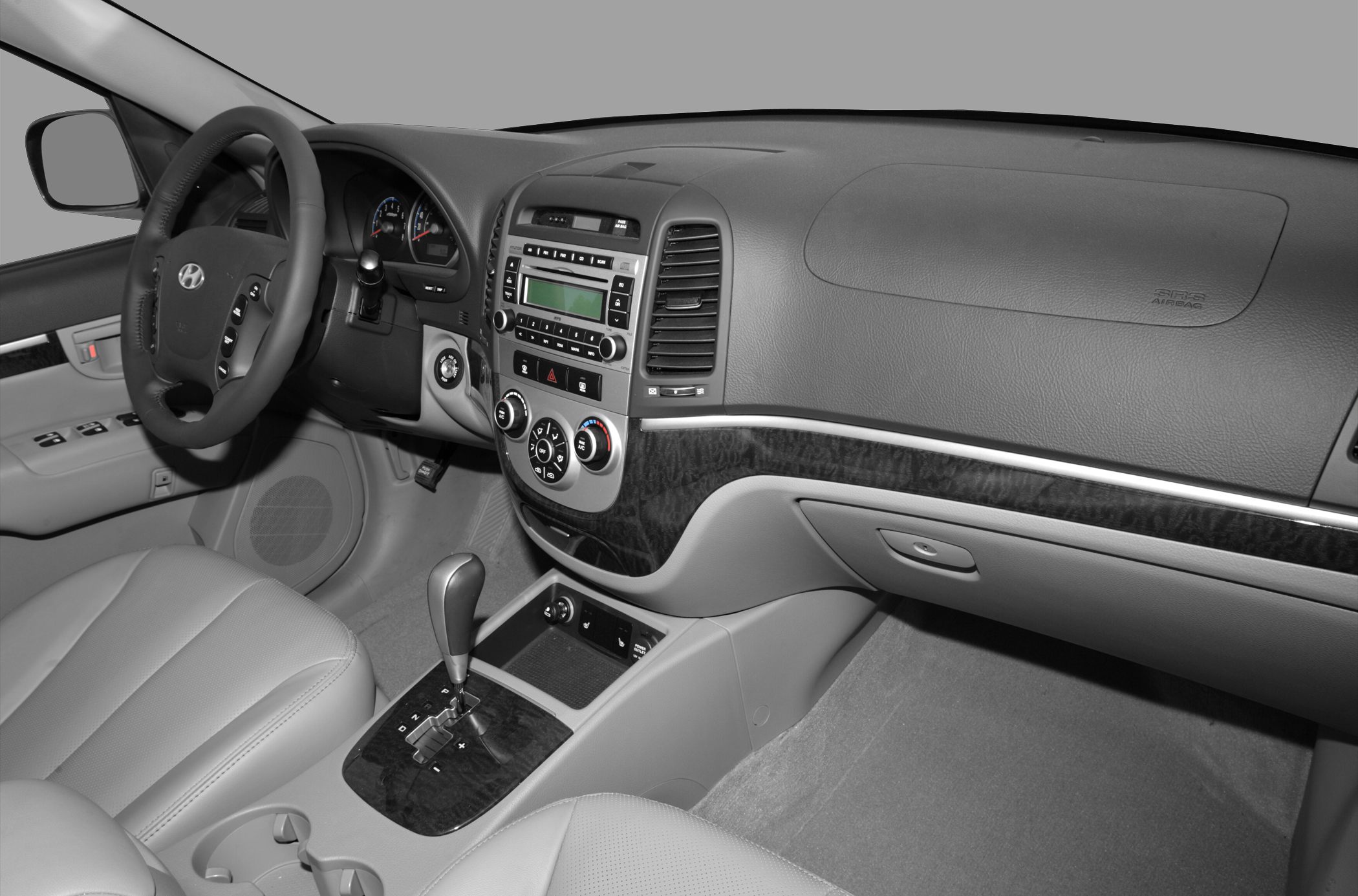 Dashboard, steering wheel, and center console with gear shifter and controls