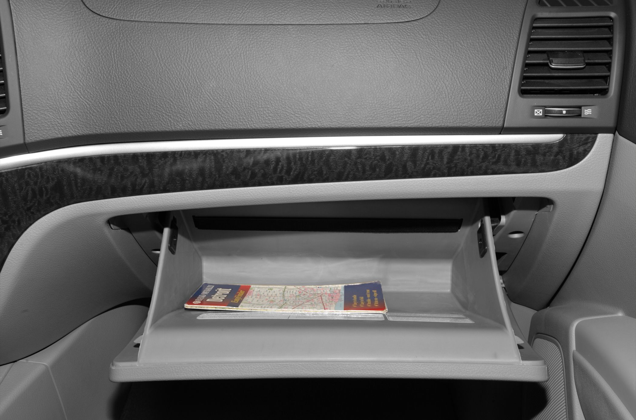 Open glove compartment with a map booklet inside