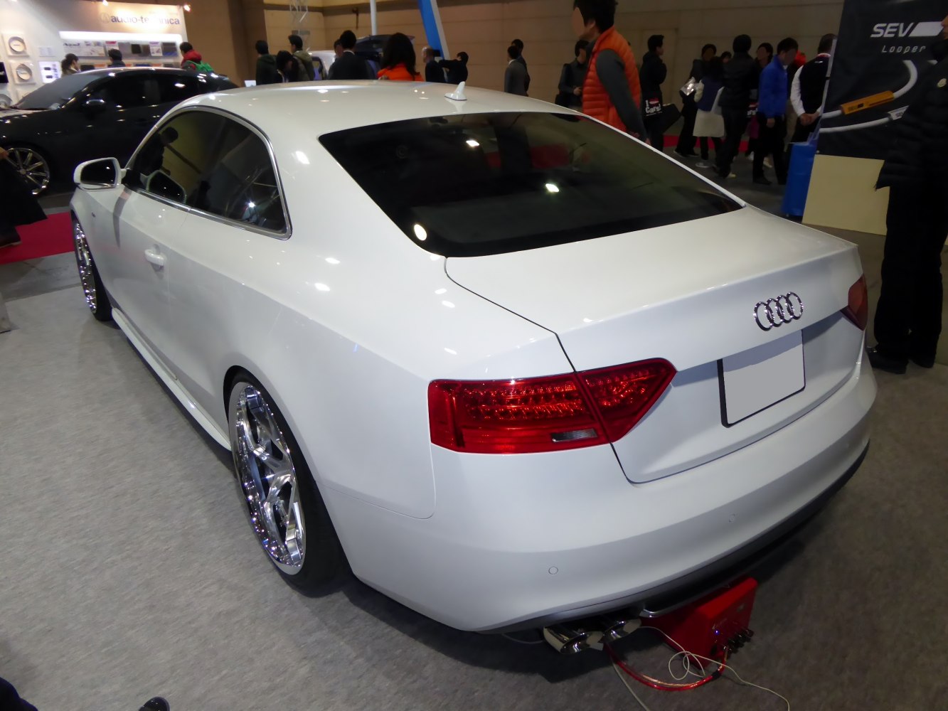 White coupe rear with LED taillights and shiny alloy wheels