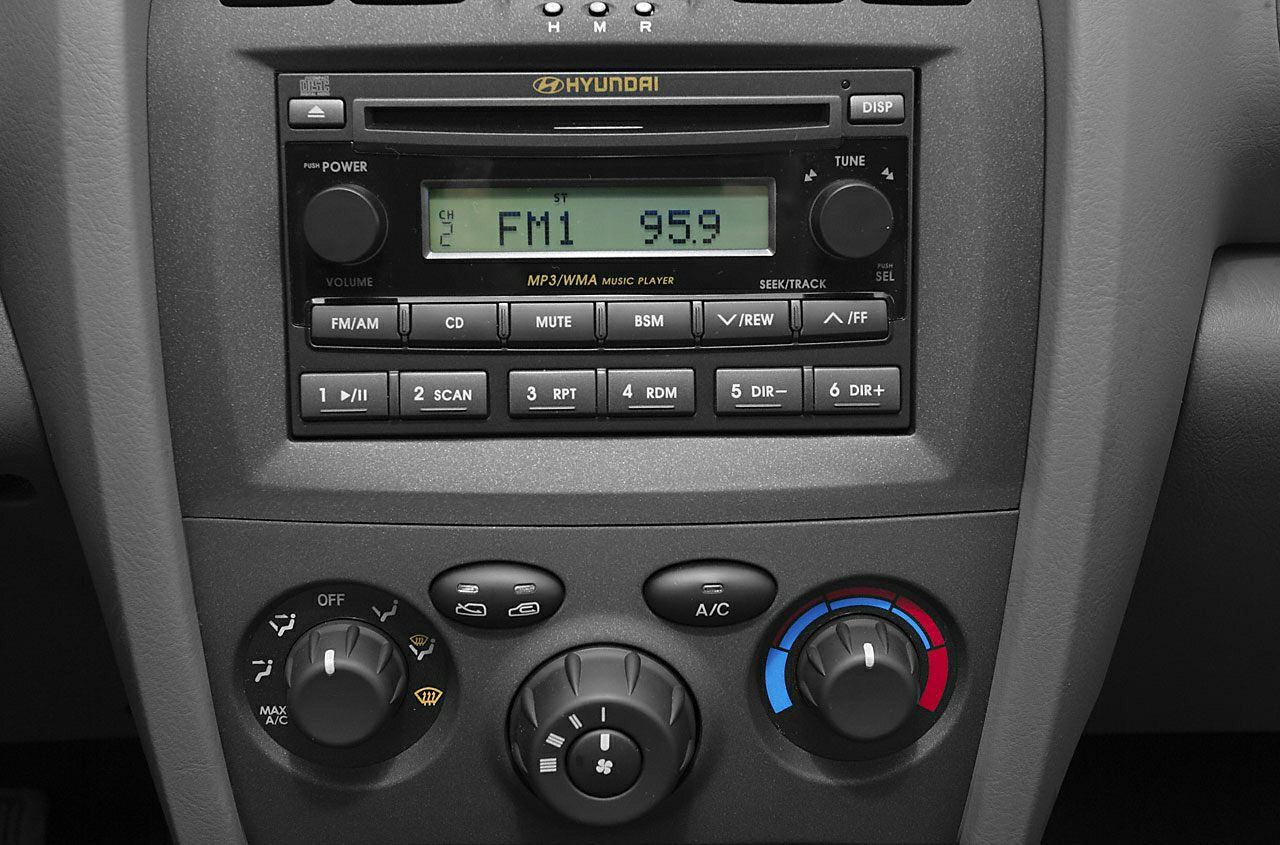 Car stereo and manual climate control panel with FM radio and AC dials