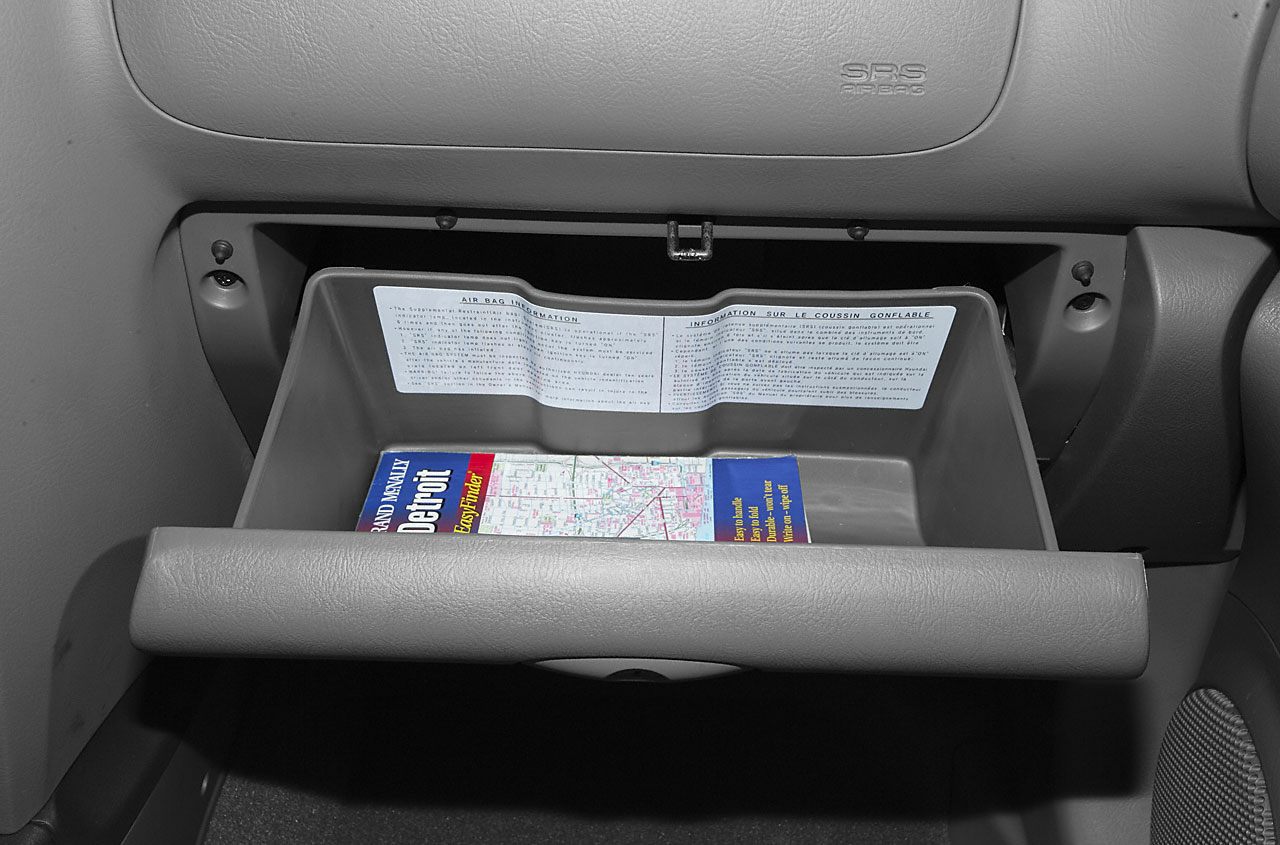 Open glove box with map inside dashboard storage compartment
