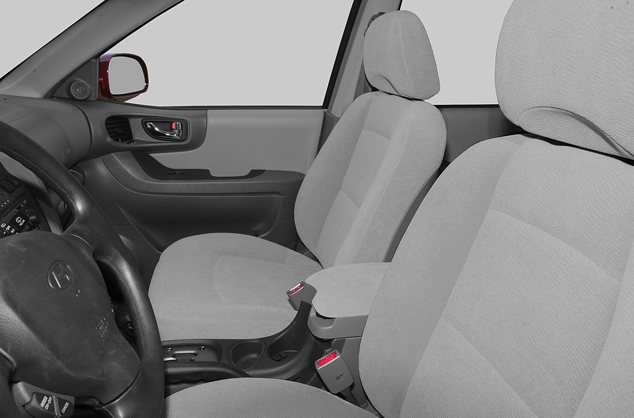 Front seats and dashboard with steering wheel and armrest