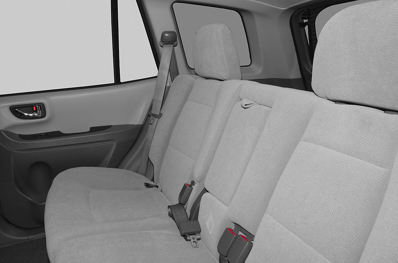 Rear seat interior with fabric upholstery and seatbelts