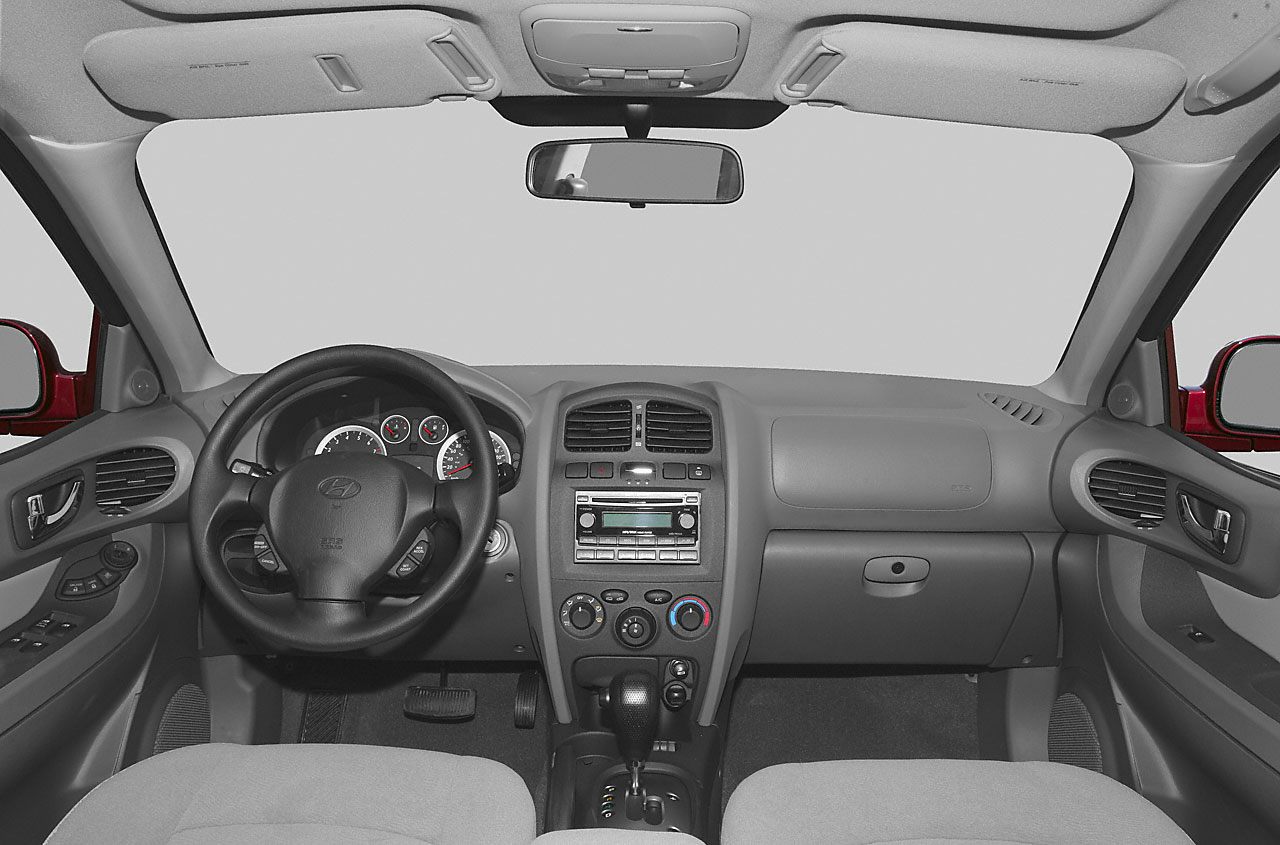 Dashboard, steering wheel, and center console of an early 2000s SUV interior