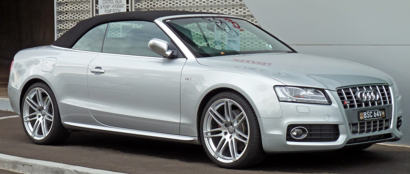 Silver luxury convertible coupe with soft top and alloy wheels