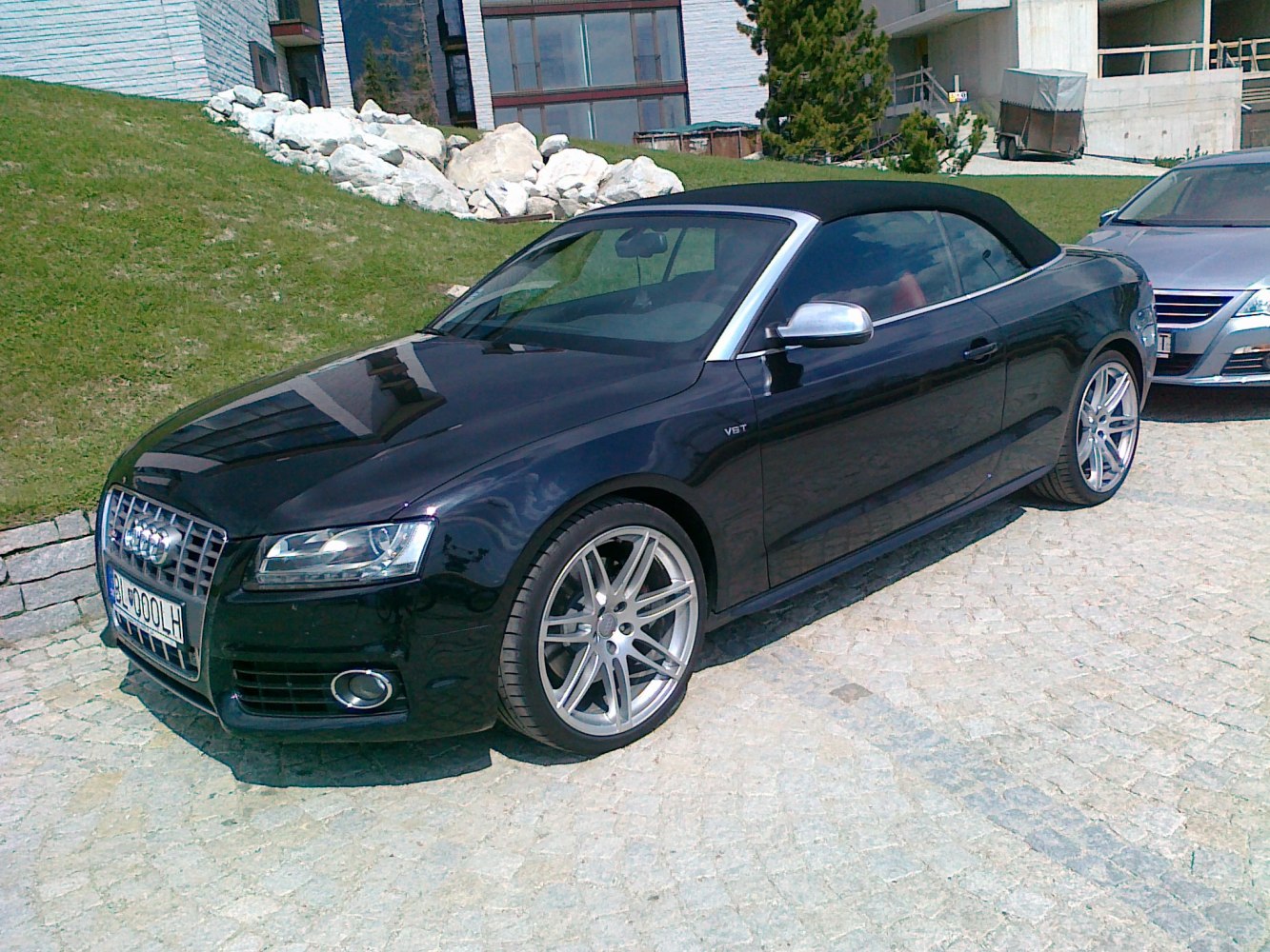 Black convertible with V8 engine and alloy wheels, front-side view