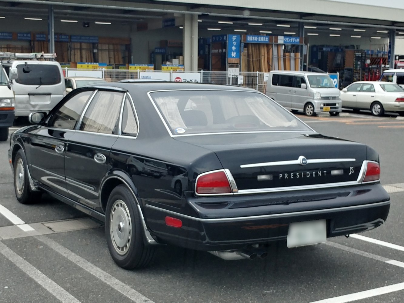 Rear view of luxury sedan with classic 1990s design elements
