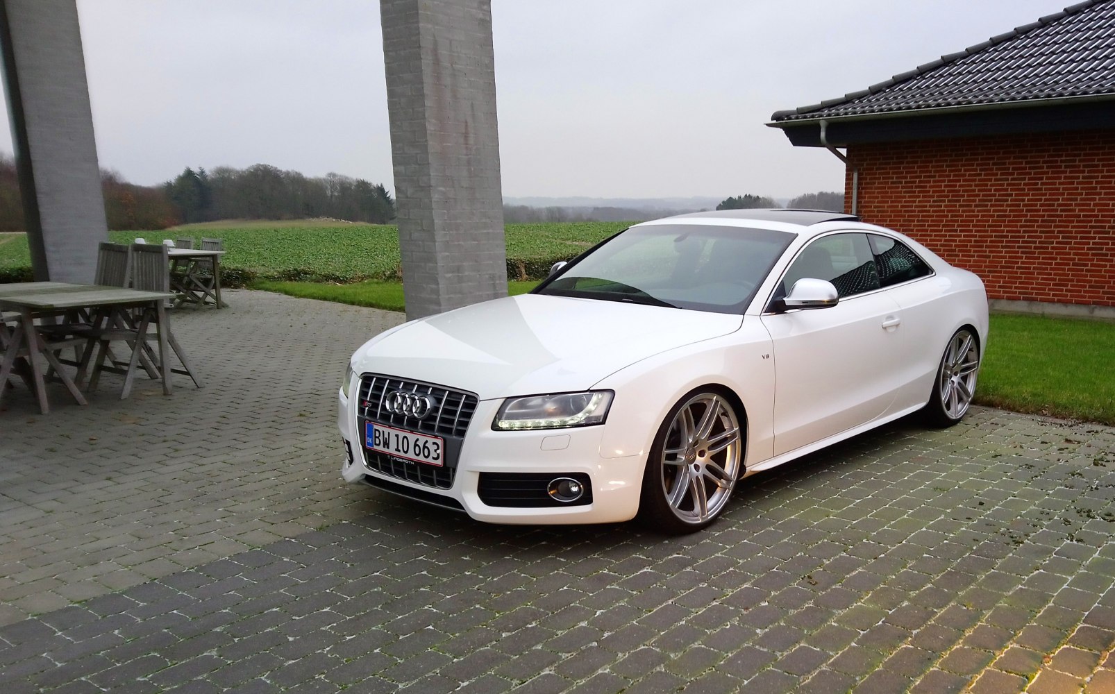 White sporty coupe with LED headlights and large alloy wheels