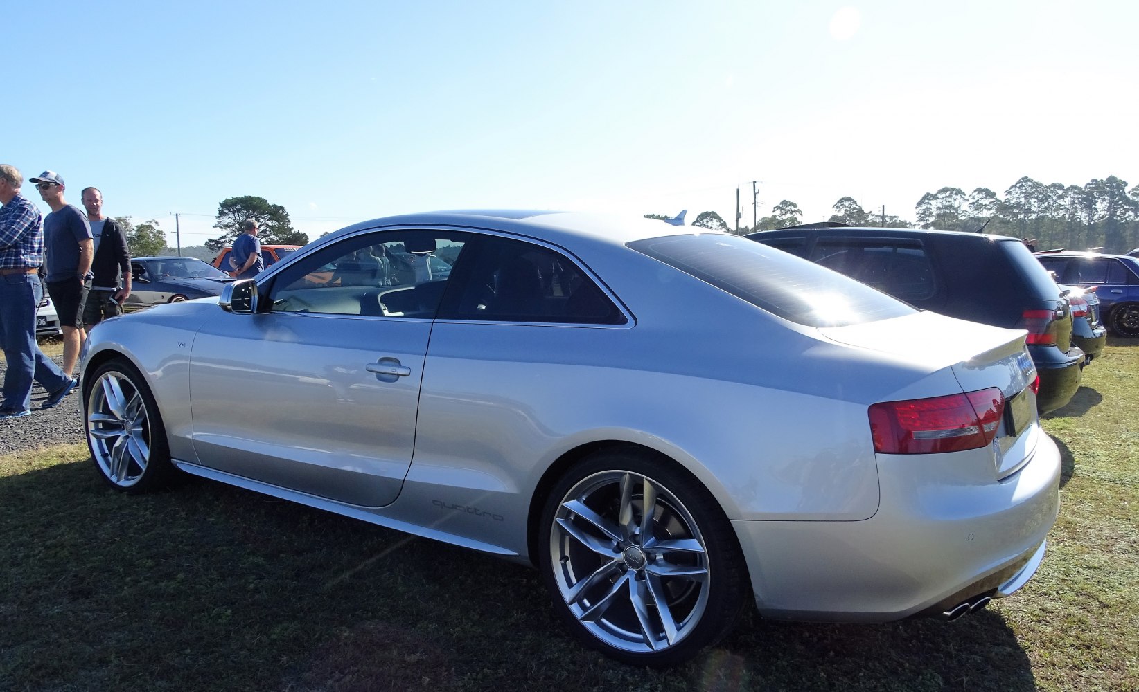 Silver two-door coupe with alloy wheels and sharp rear taillights