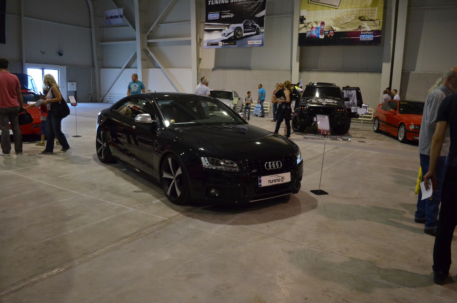 Black sporty coupe with silver mirrors and bold black-silver rims