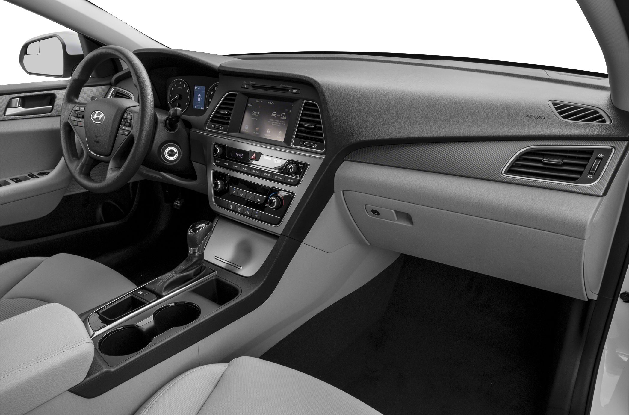 Dashboard and center console with steering wheel, gear shift, and infotainment system