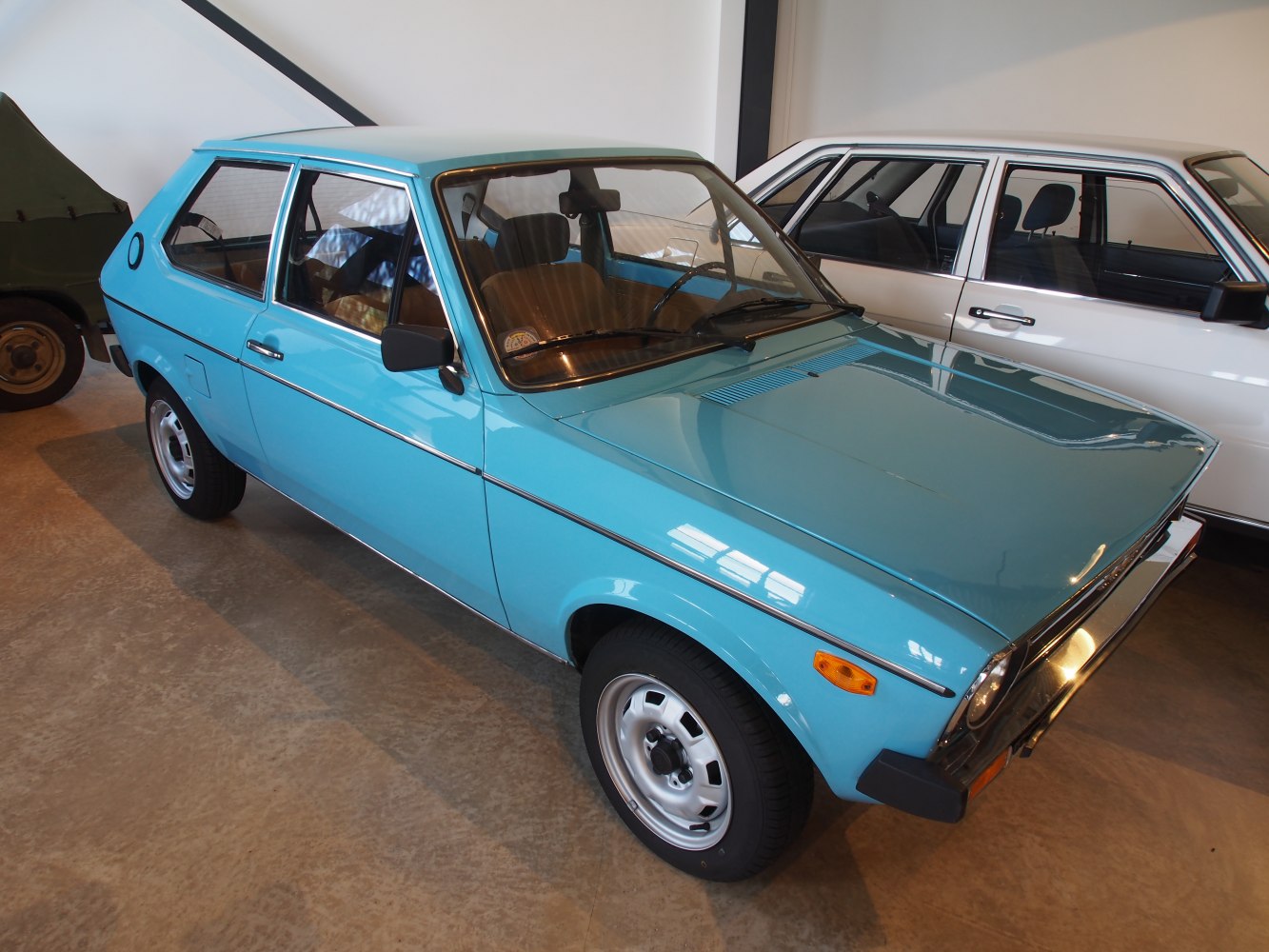 Vintage compact blue hatchback with angular 1970s design