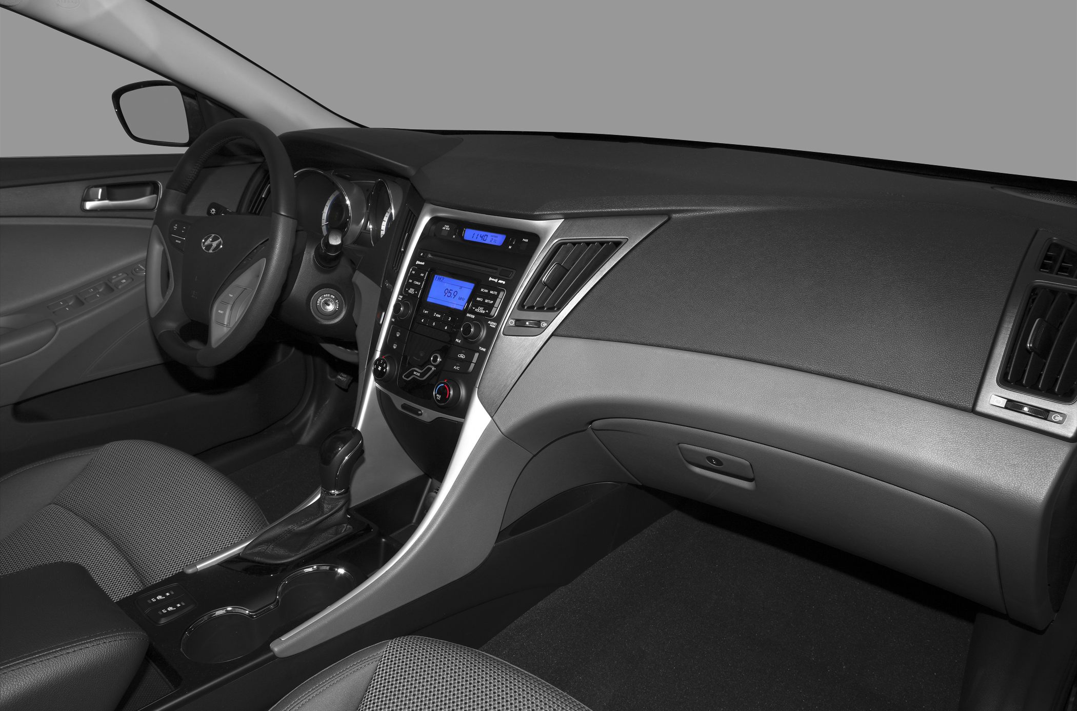 Car interior with dashboard, steering wheel, and center console