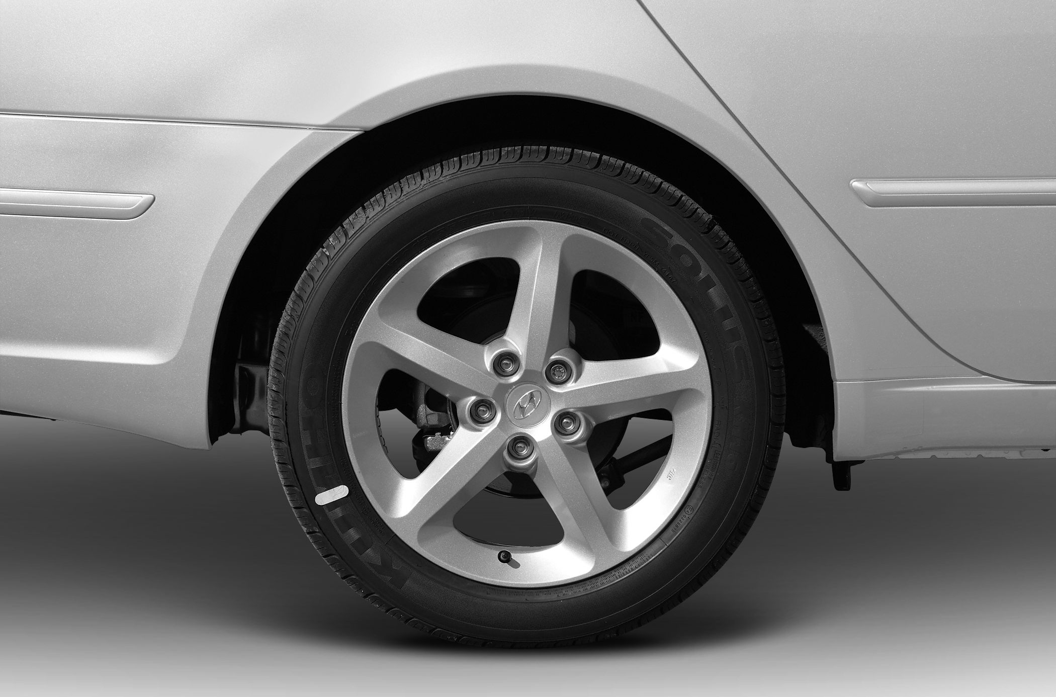 Rear alloy wheel and quarter panel of a sedan