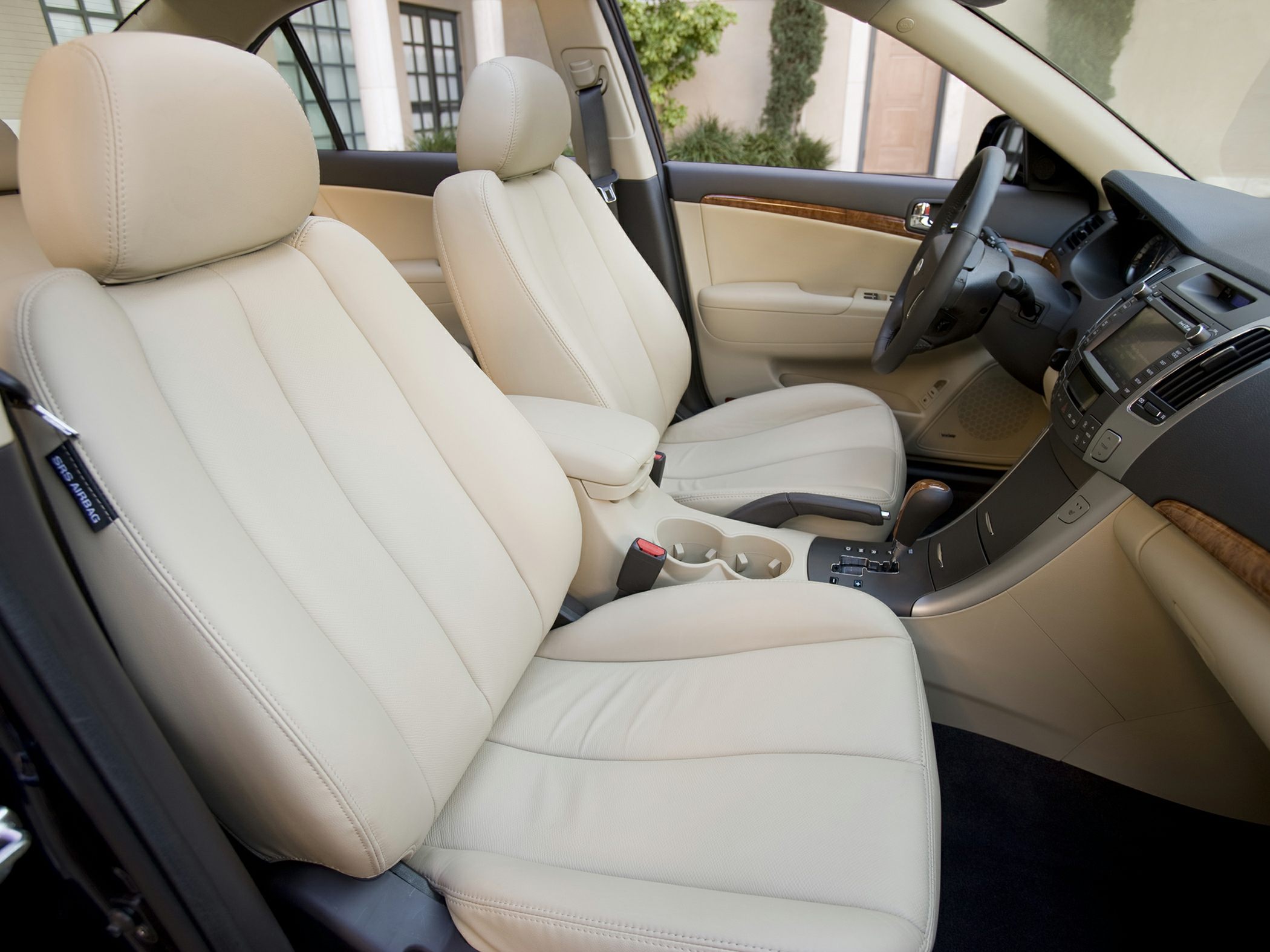 Beige leather seats and wood trim interior with automatic transmission.