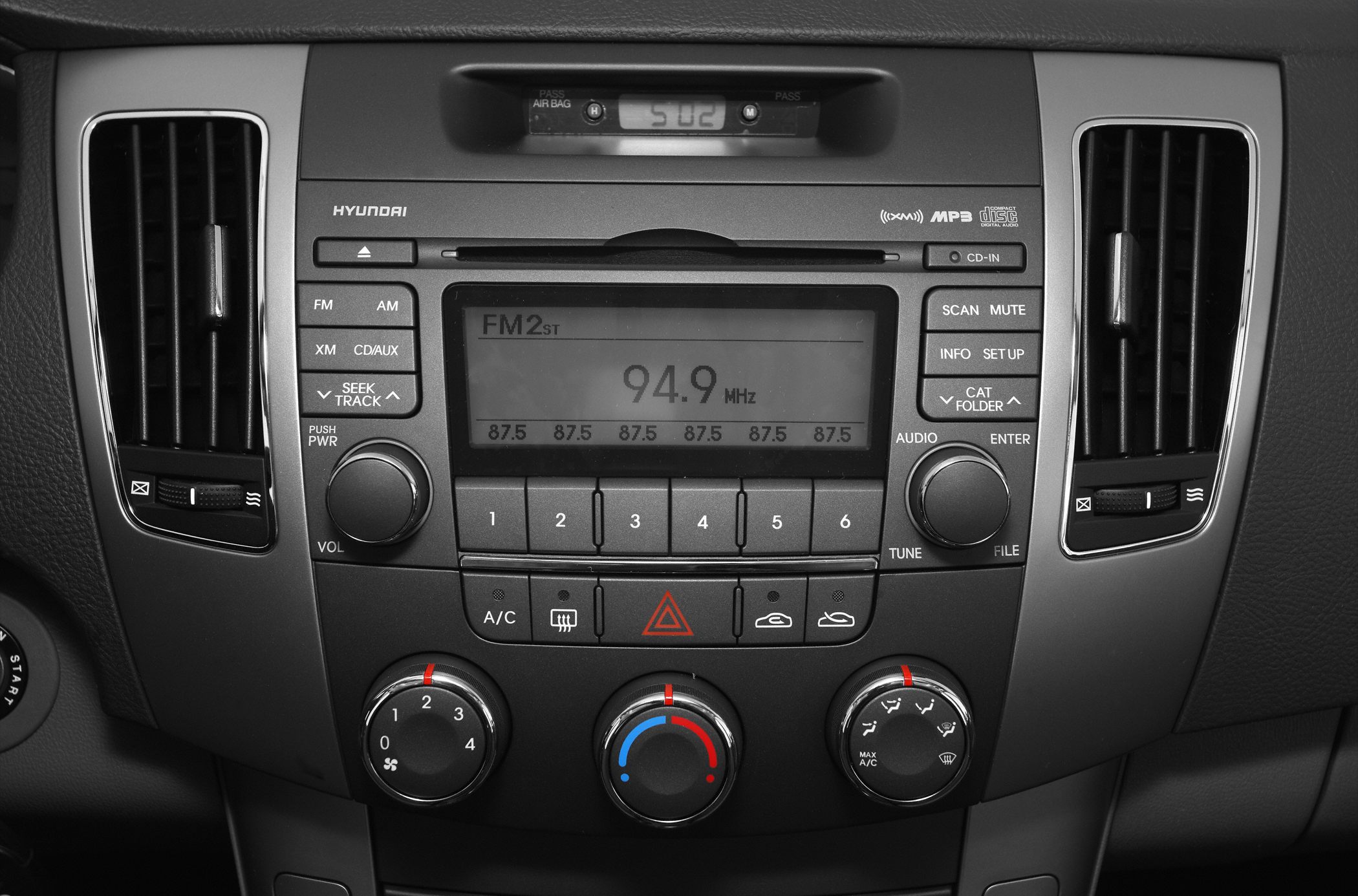 Radio and climate control panel with FM, AM, XM, CD, AUX, and temperature knobs