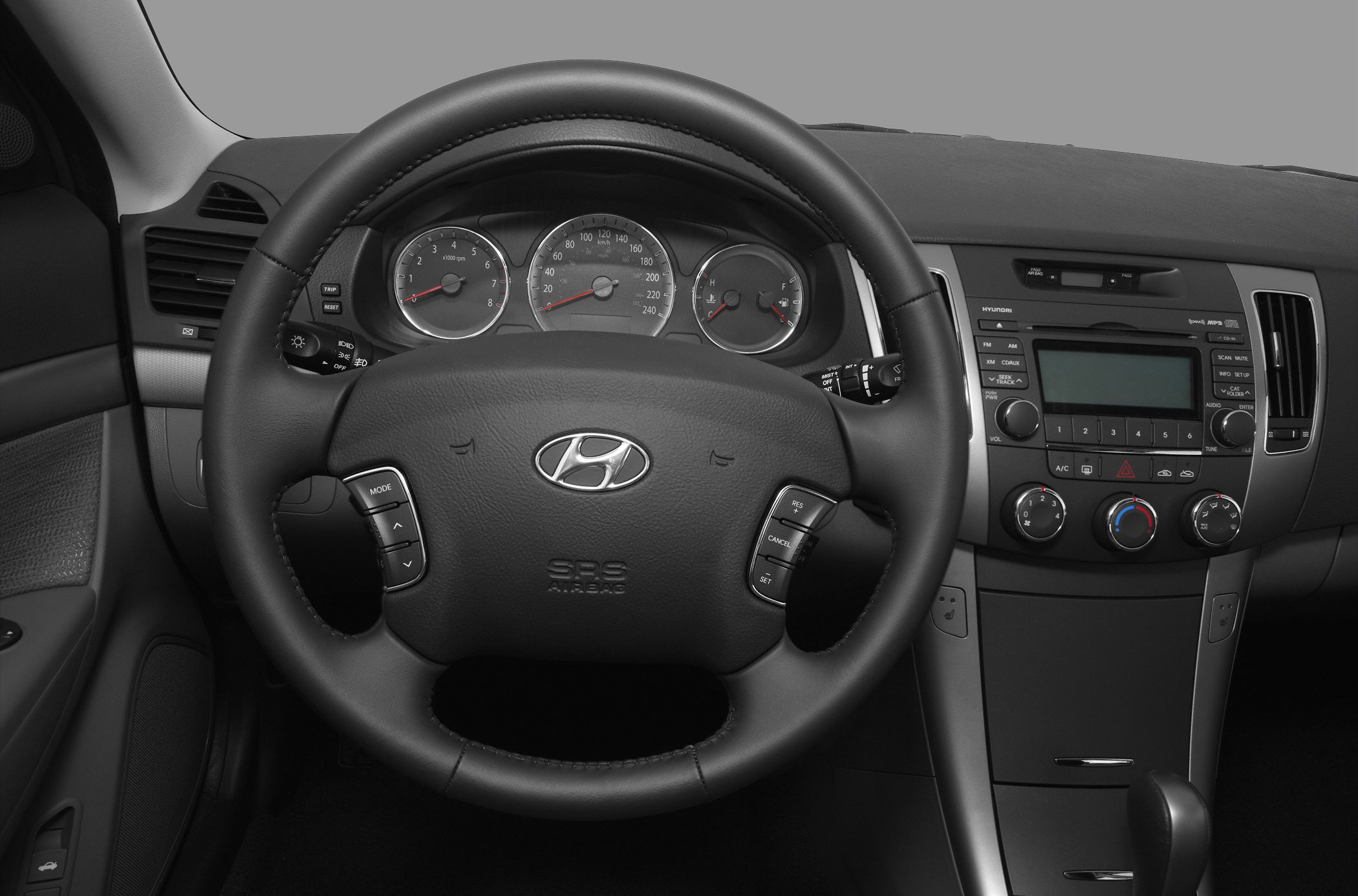 Steering wheel with integrated controls and central dashboard with audio and climate controls