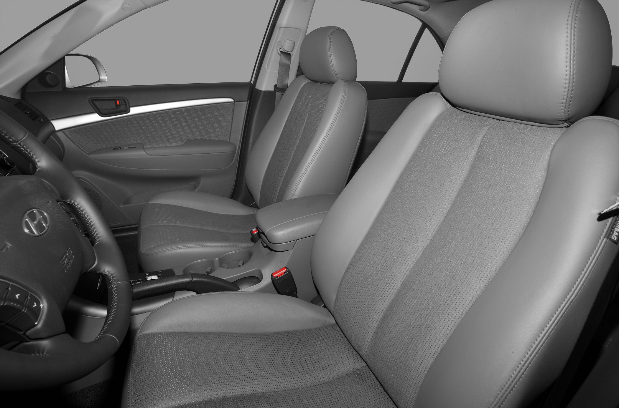 Front seats and dashboard interior of mid-2000s sedan