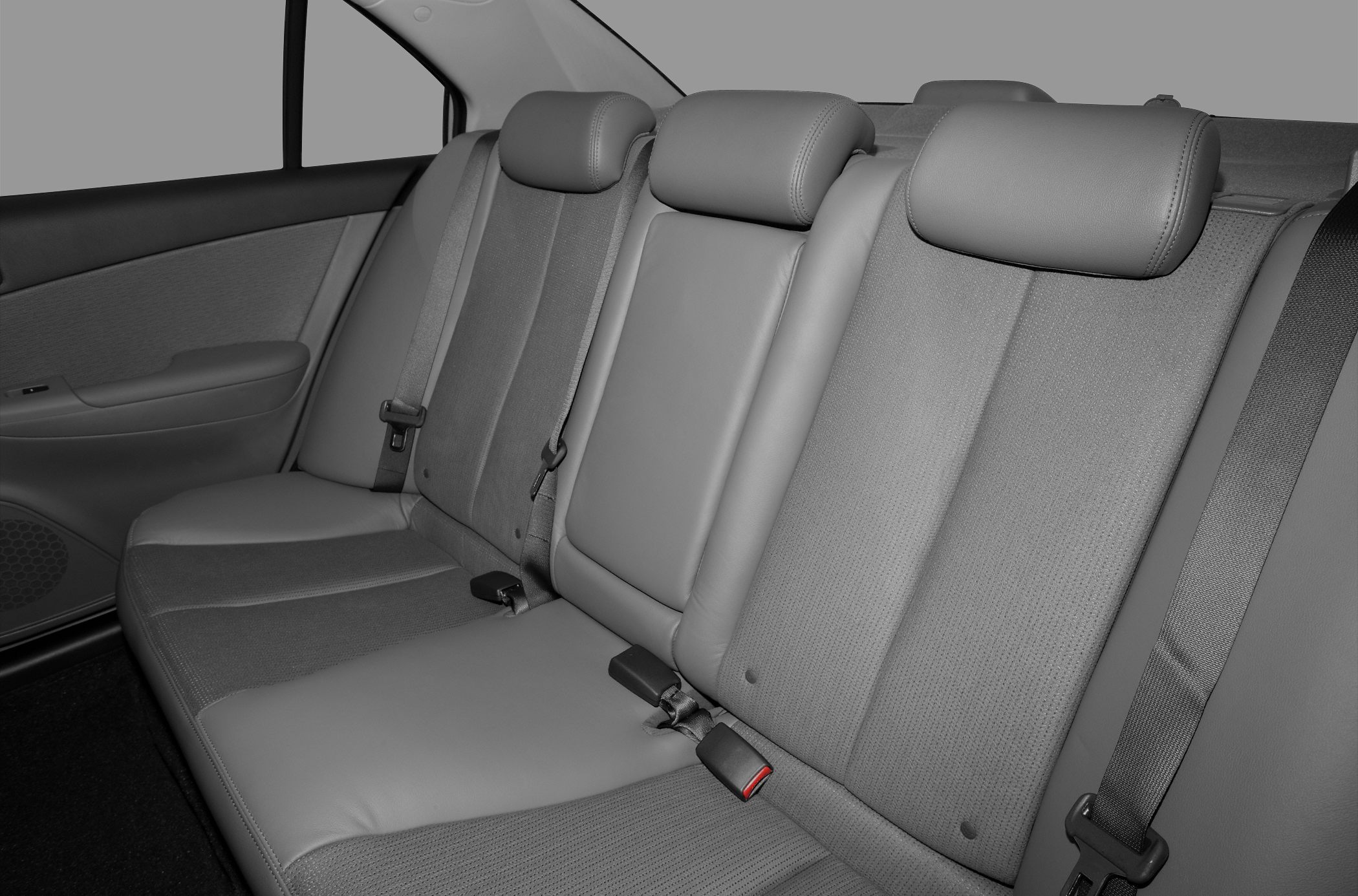 Rear seat with fabric and leather upholstery, adjustable headrests, and seat belts