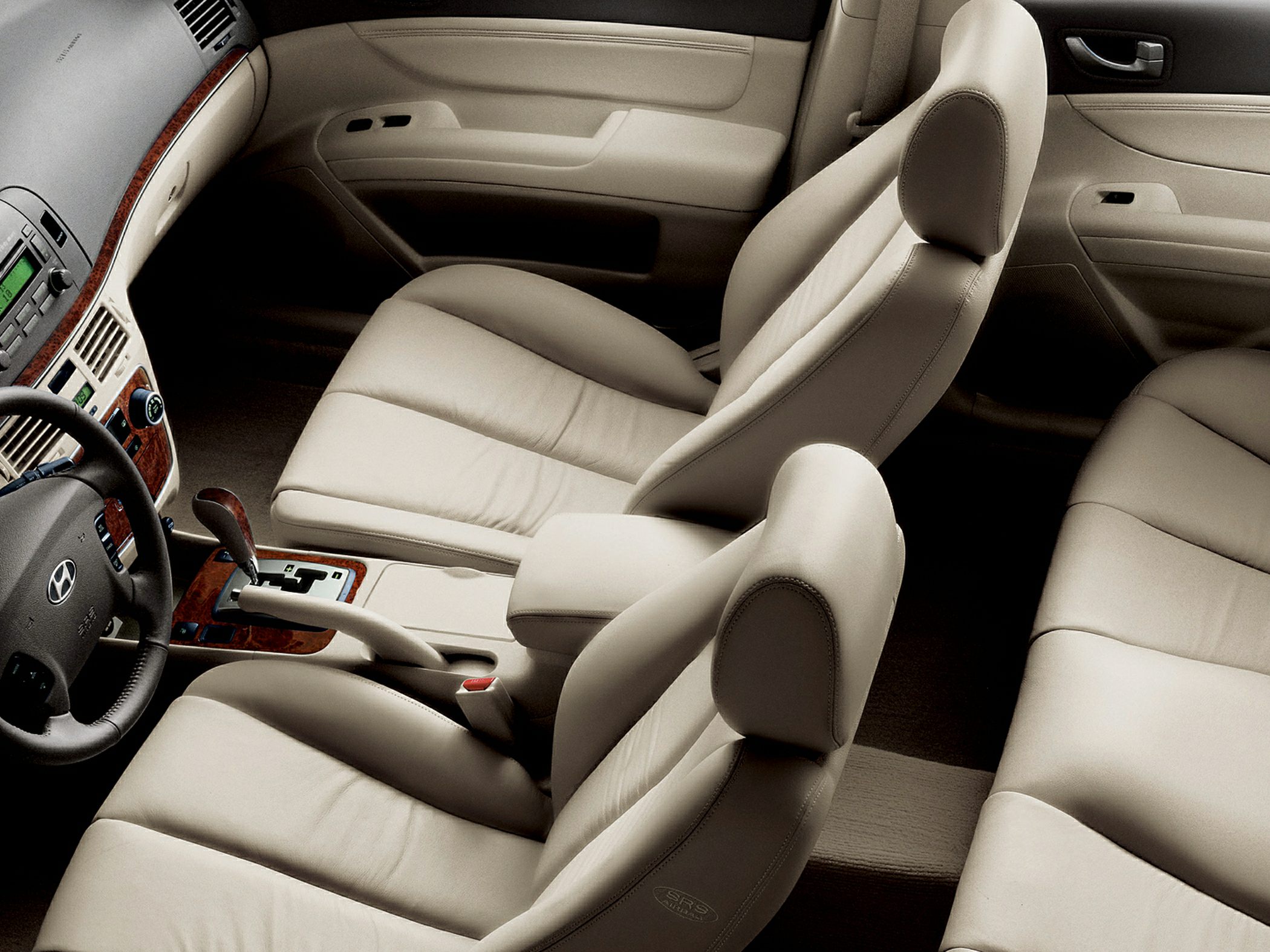 Beige leather seats and detailed car interior with automatic transmission