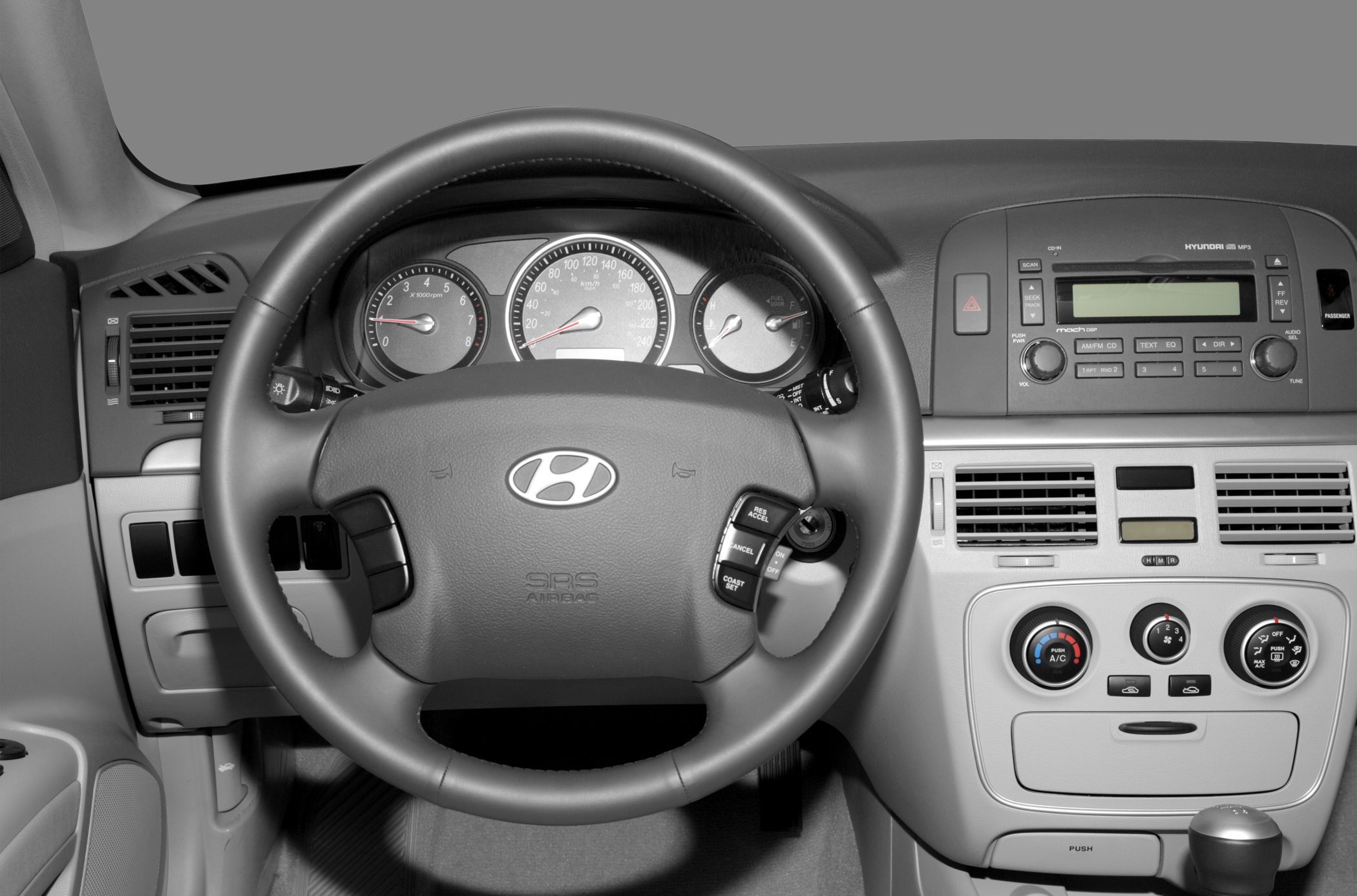 Dashboard and steering wheel with instrument cluster and center console controls.