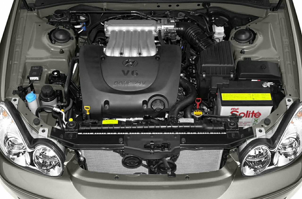 V6 DOHC 24V engine bay with battery, radiator, and air intake components