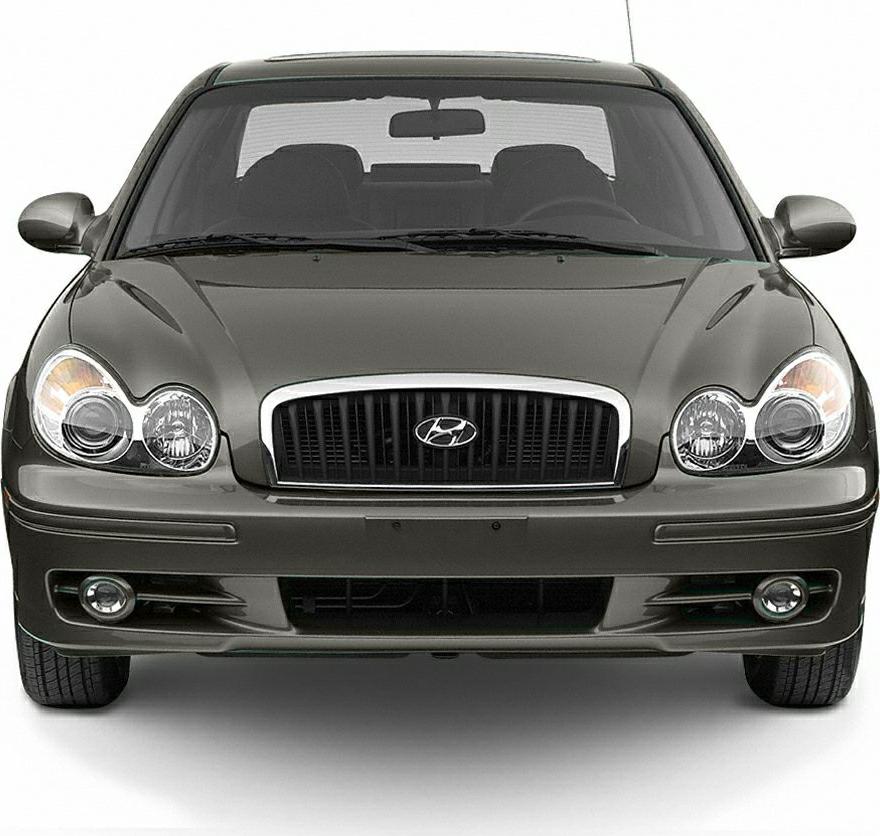 Dual headlights and grille with fog lights on front of sedan