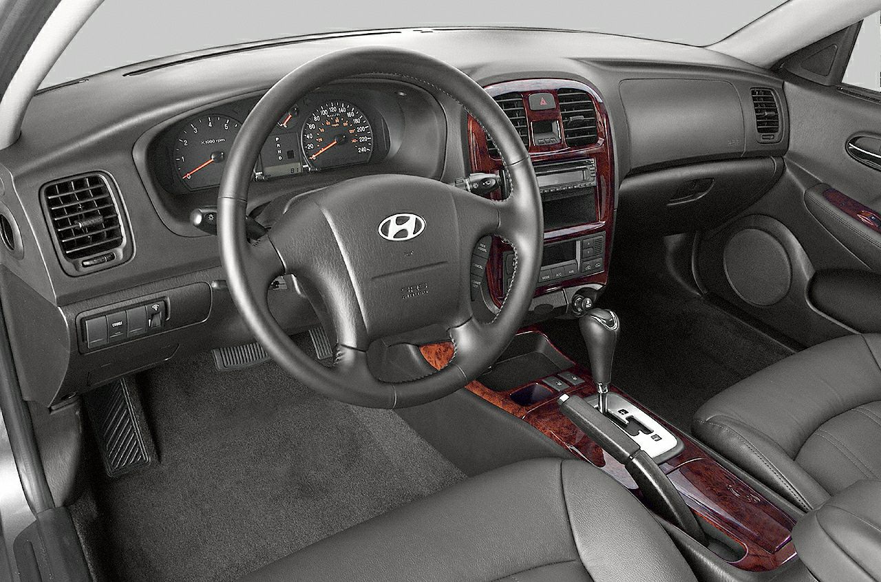 Black leather interior with wood trim and automatic gear shifter