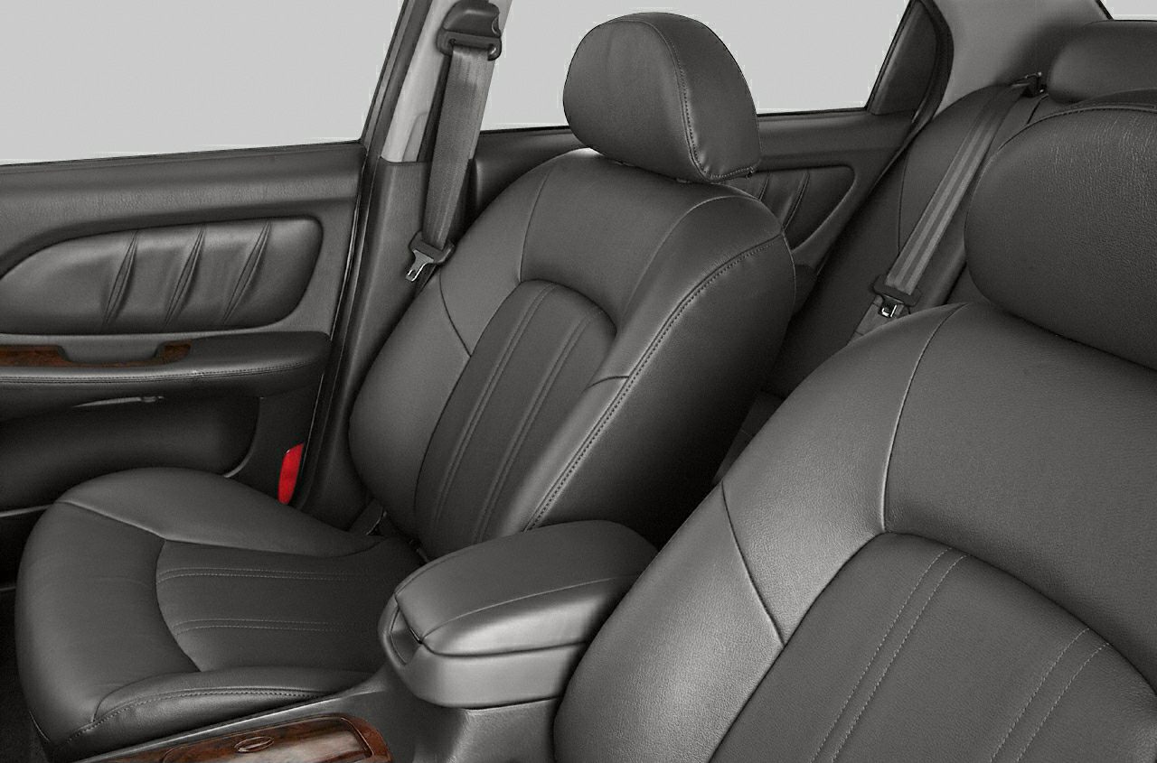 Black leather front seats and door panel with wood trim and seatbelt
