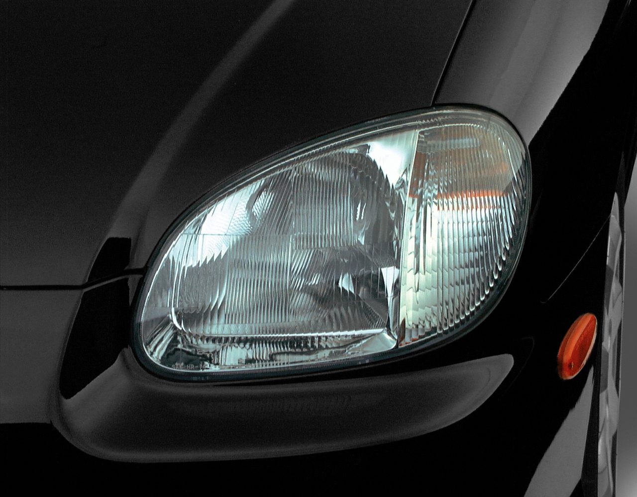 Close-up of classic clear segmented front headlight and side marker light
