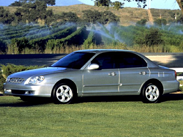 Silver four-door sedan with alloy wheels, side profile view
