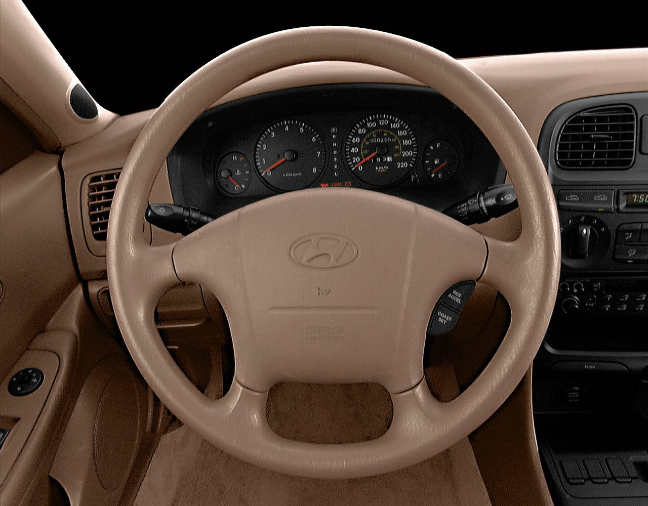 Beige leather steering wheel and instrument cluster with dashboard controls