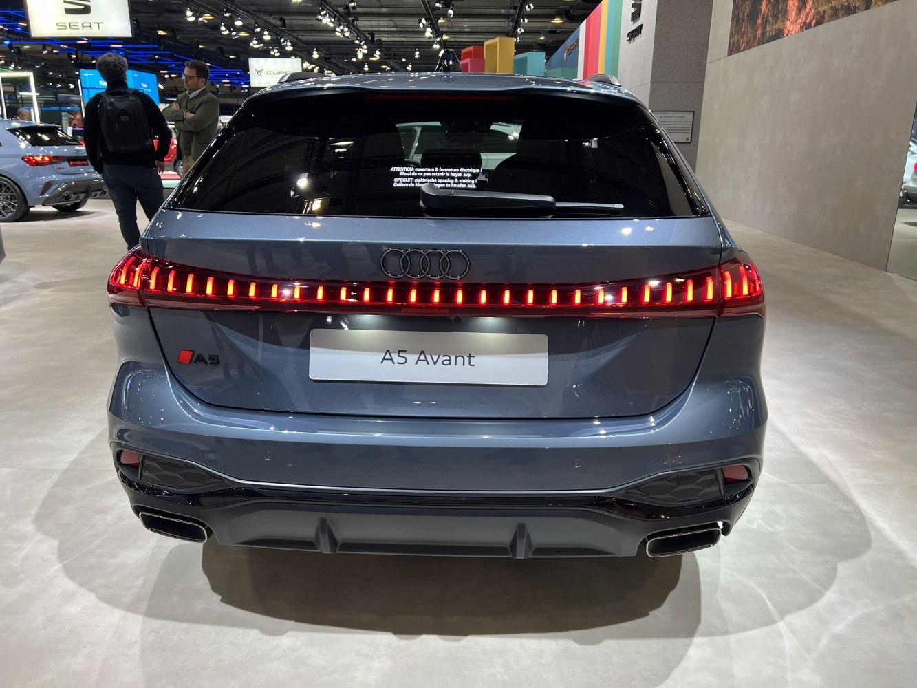 Continuous LED tail light strip and dual exhaust outlets at rear