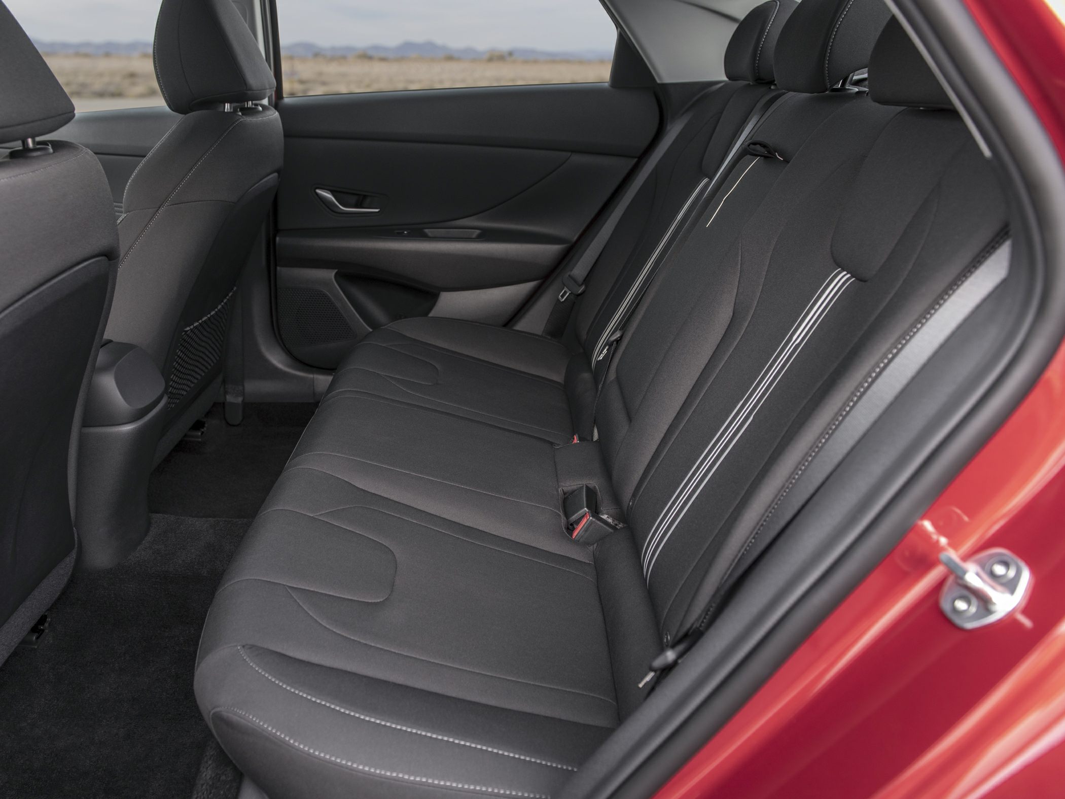Modern rear seat interior with fabric upholstery and three seat belts