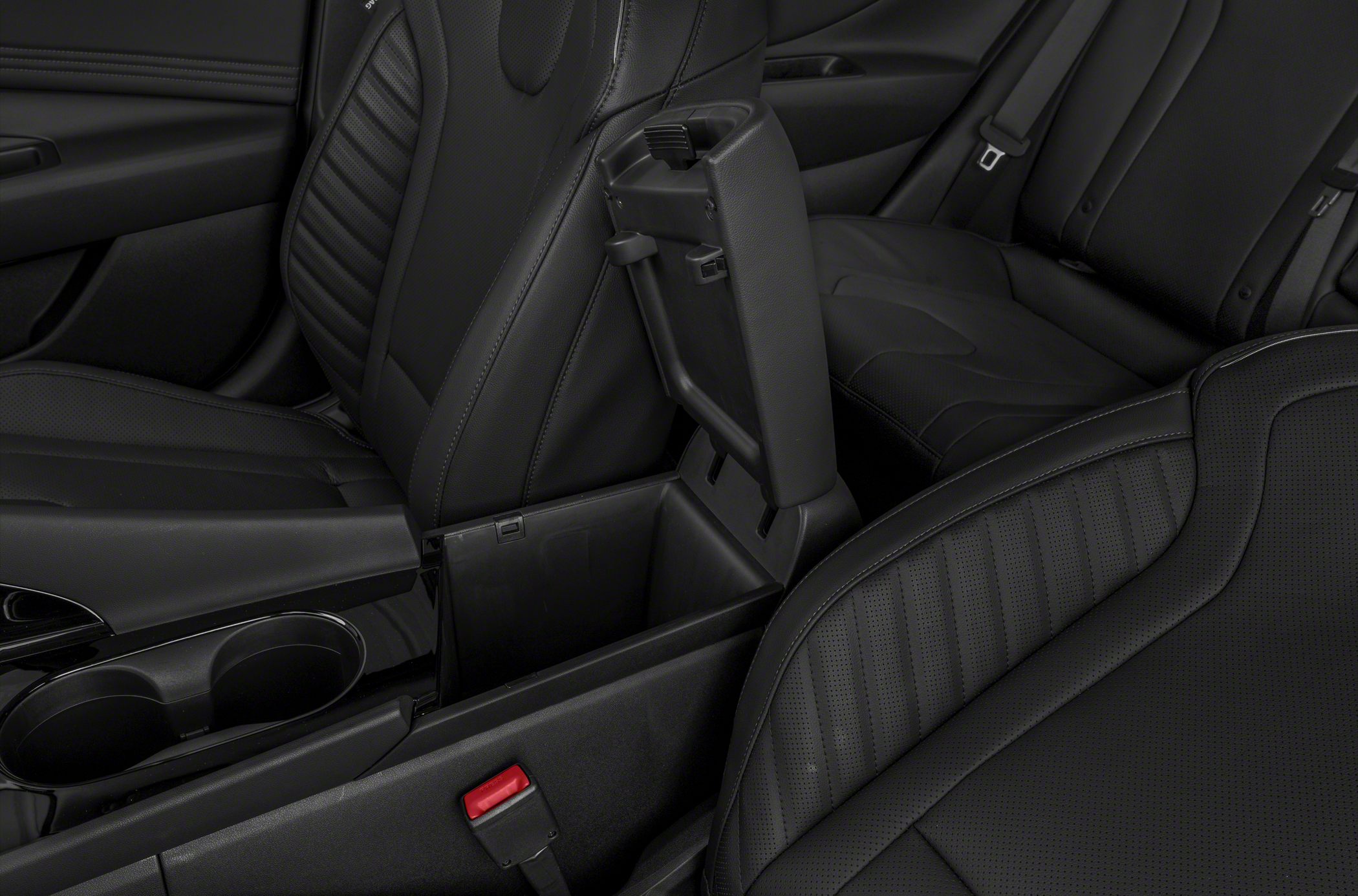 Center console storage and black leather seats interior close-up