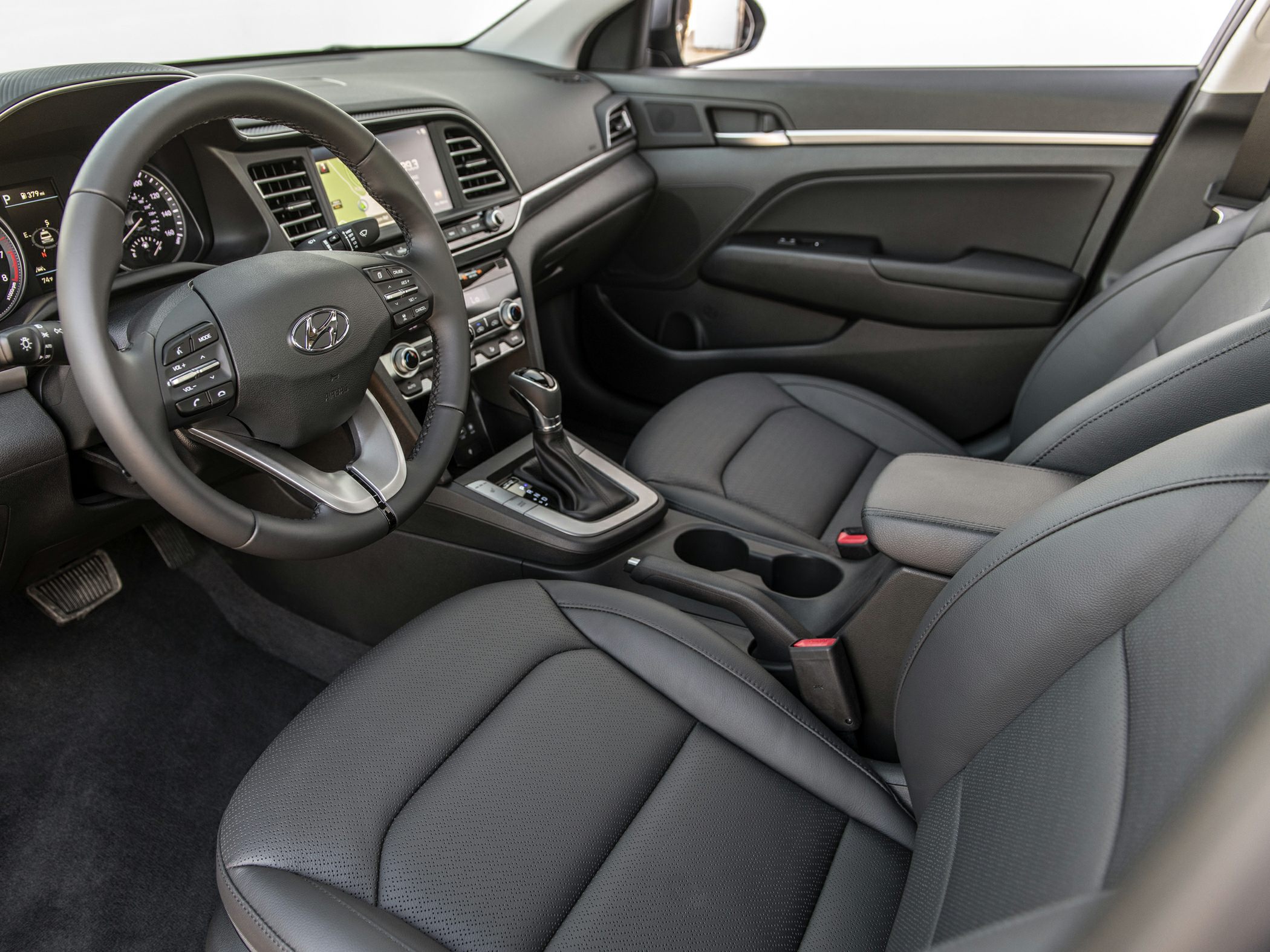 Modern dashboard and steering wheel with leather seats inside a vehicle