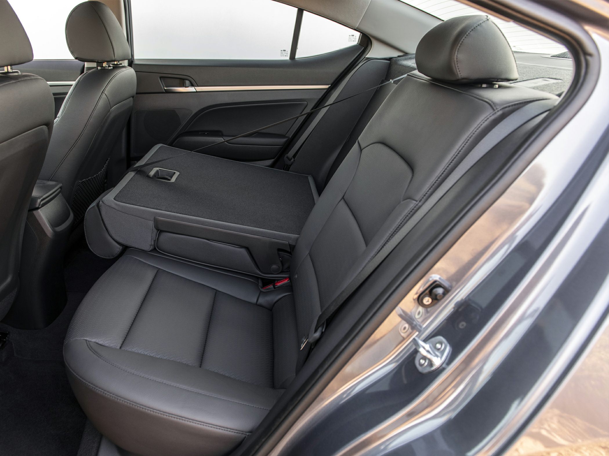 Fold-down rear seats with leather upholstery in a modern sedan interior