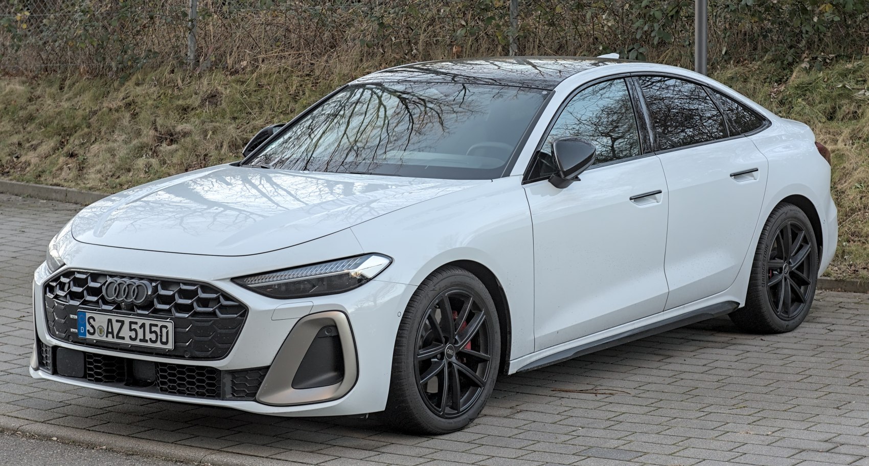 Sporty white sedan with black accents and sleek LED headlights