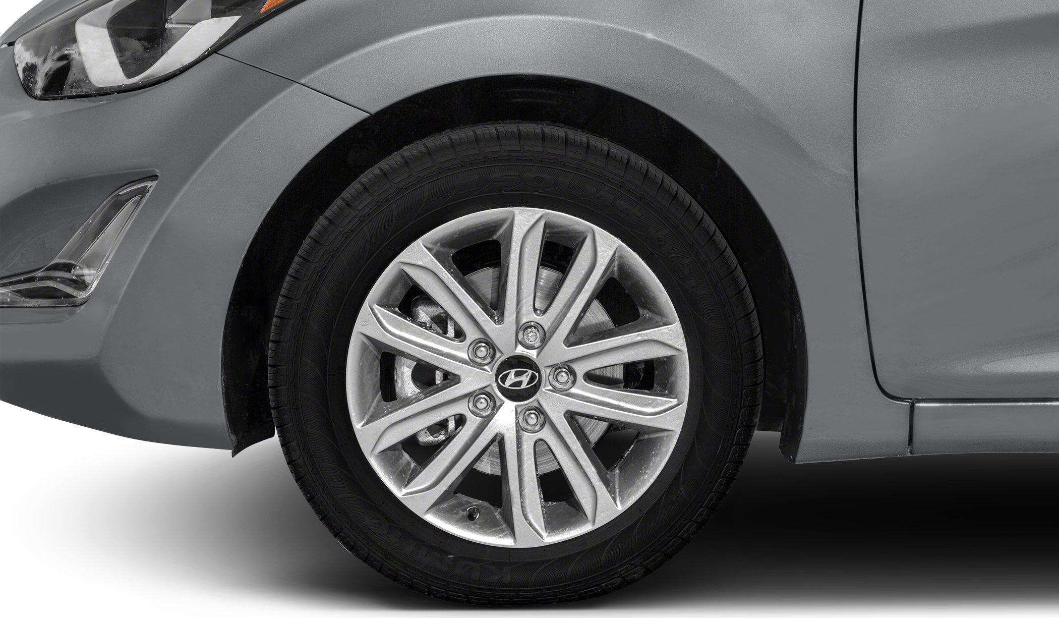 Close-up of alloy wheel and front fender with headlight.