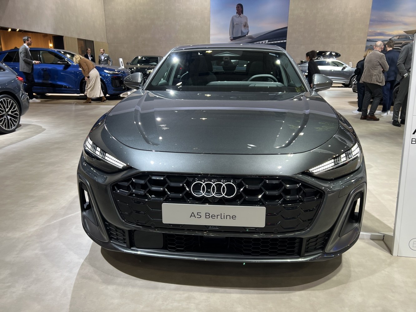 Front view of a sleek sedan with modern LED headlights and bold grille
