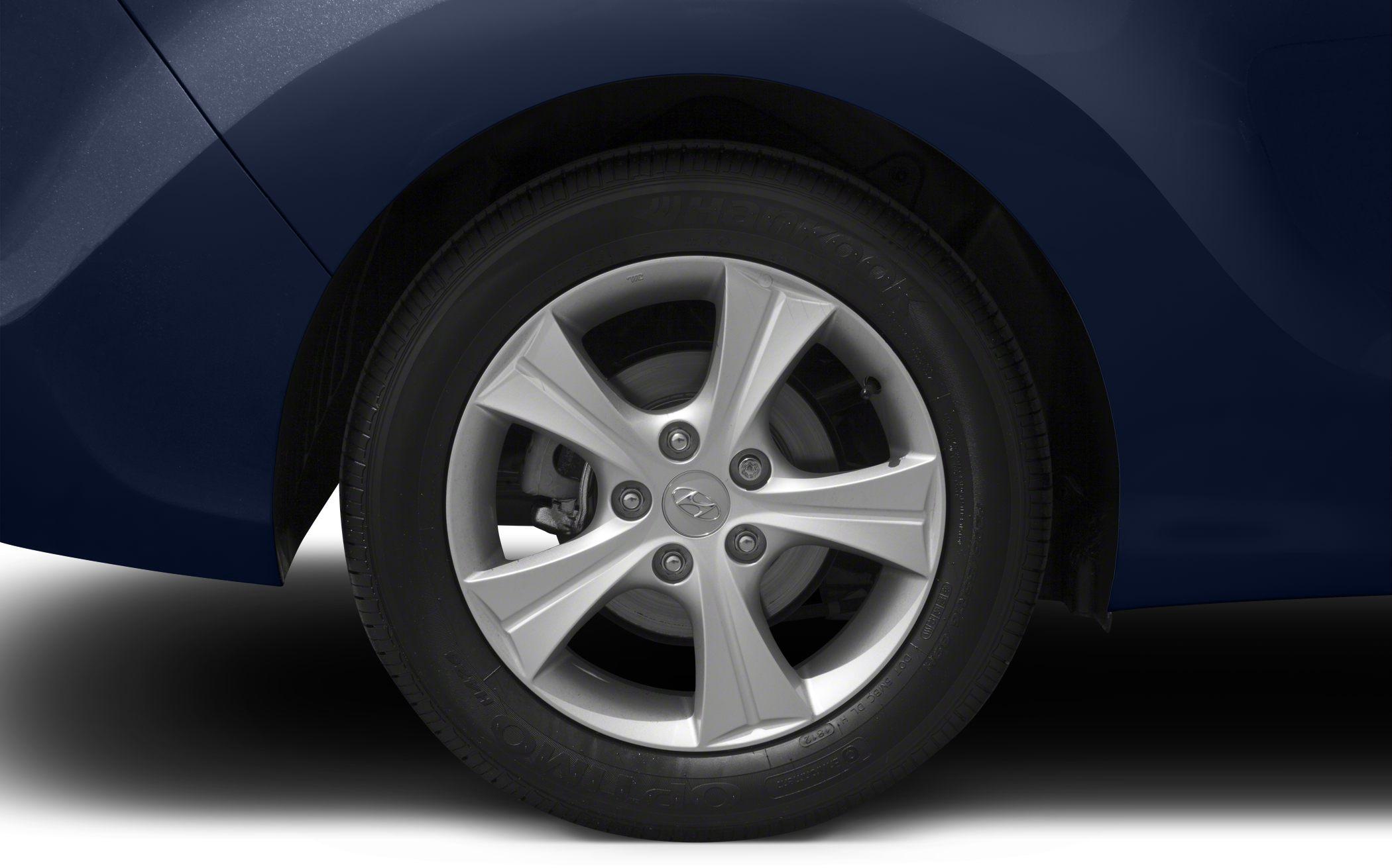 Five-spoke alloy wheel with Hankook tire on dark blue car body