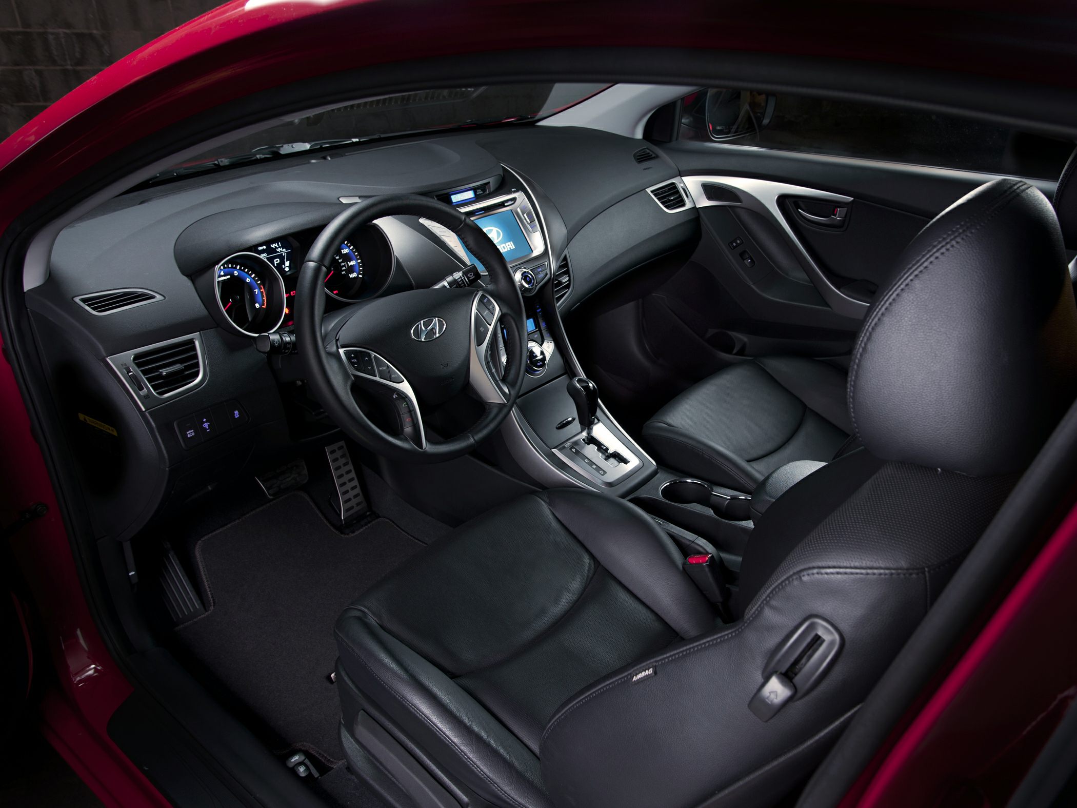 Modern car interior with dashboard, steering wheel, and leather seats