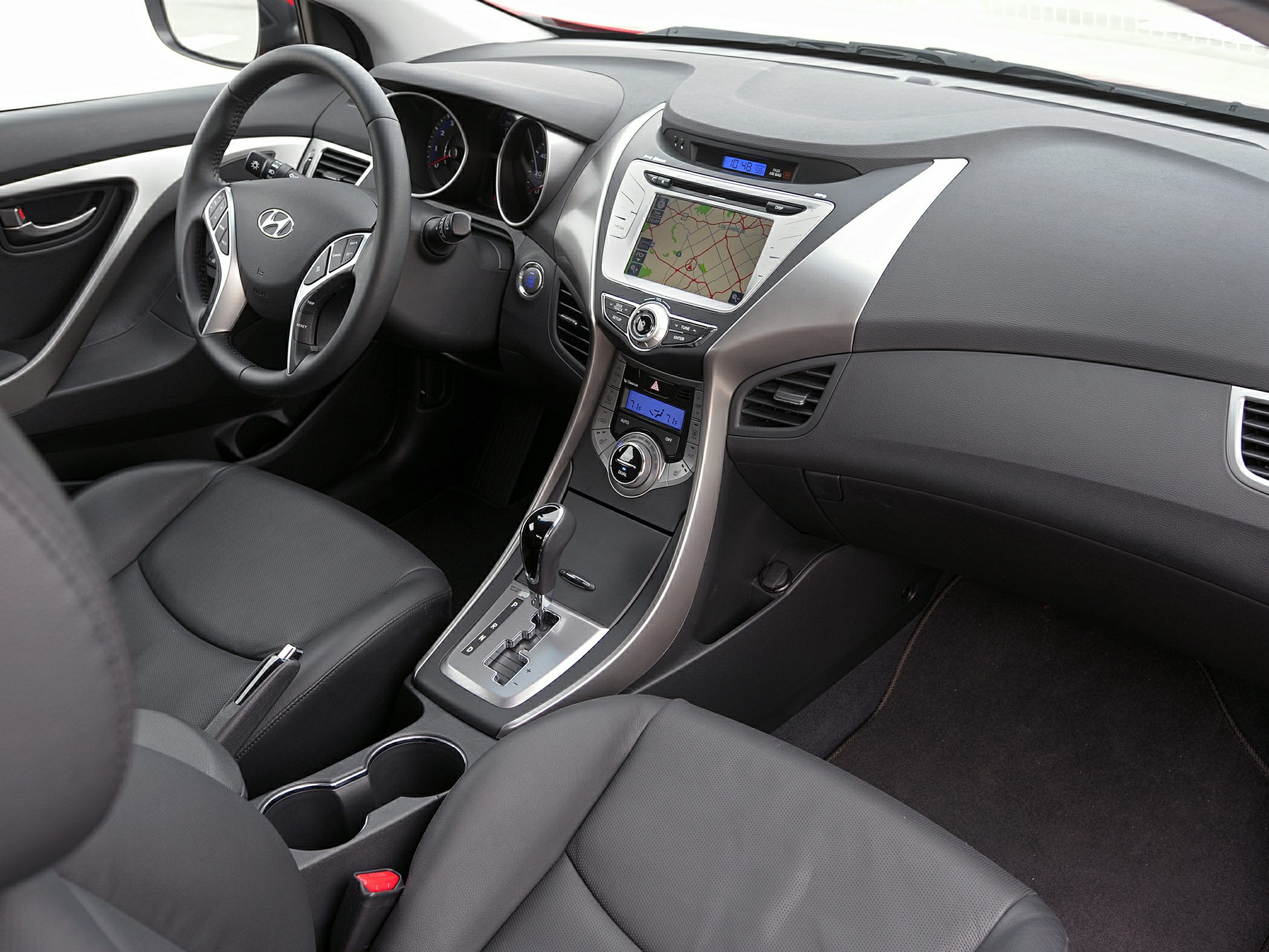 Touchscreen navigation and leather seats in modern car interior